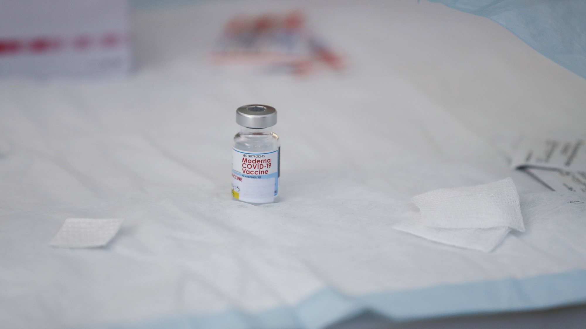 epa09482475 A vial containing Moderna Covid-19 vaccine sits on a table at a clinic for individuals experiencing homelessness at San Julian Park in Los Angeles, California, USA, 22 September 2021.  EPA/CAROLINE BREHMAN
