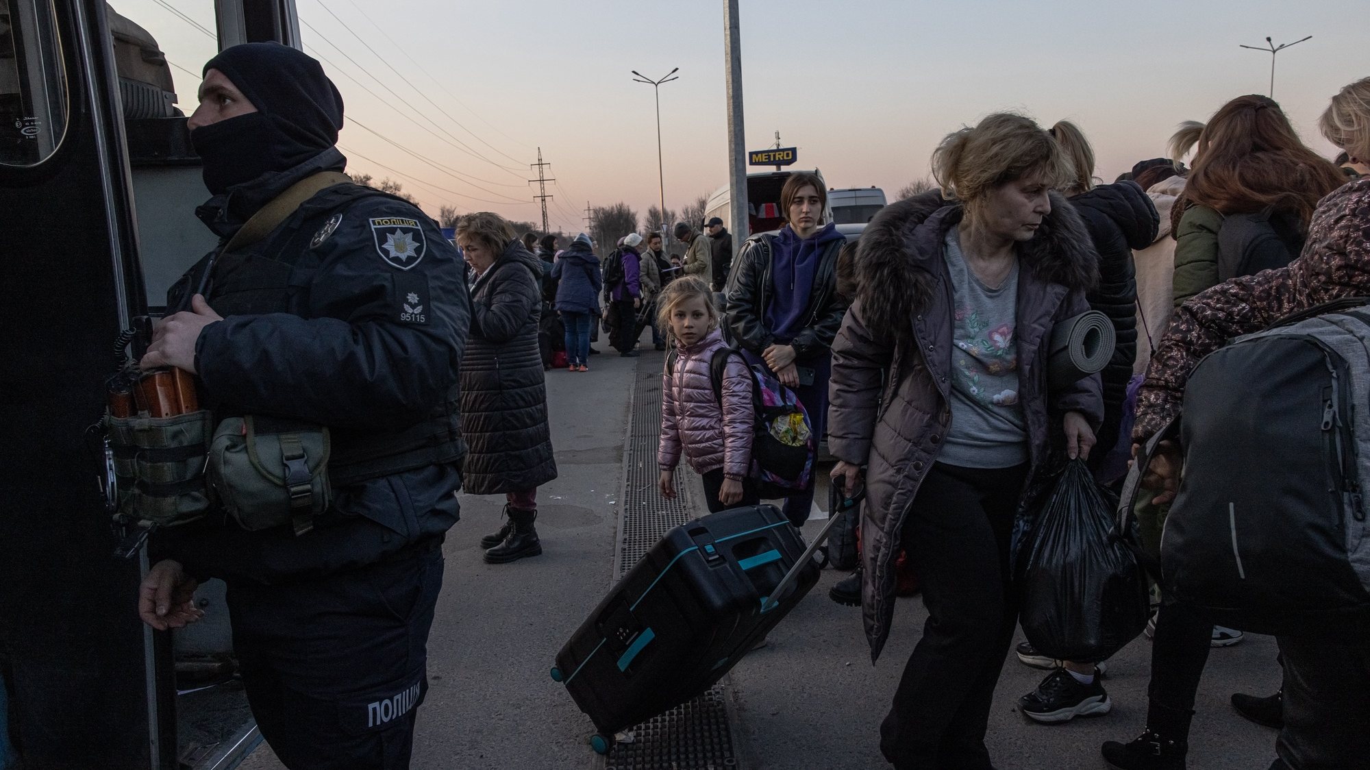epa09850008 People who fled from the besieged by Russian military southeastern city of Mariupol and occupied Melitopol gather after arriving at the evacuation point in Zaporizhzhia, Ukraine, 25 March 2022. Hundreds of people were evacuated on 25 March from the southeastern cities of Mariupol and Melitopol and arrived in Ukraine&#039;s controlled area by buses and their own cars. Almost 100,000 residents remain trapped and live in &#039;inhuman conditions&#039; without food and water in the ruined city of Mariupol, amid Russia&#039;s &#039;constant shelling&#039;, Ukrainian president Volodymyr Zelenskyy says.  EPA/ROMAN PILIPEY
