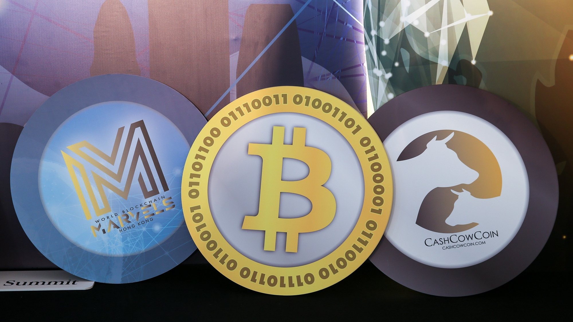 epa09485704 (FILE) - Logos of (L-R) the World Blockchain Marvels, and cryptocurrencies Bitcoin, and CashCowCoin are displayed during the World Blockchain Marvels in Hong Kong, China, 24 August 2018 (reissued 24 September 2021). China&#039;s People&#039;s Bank on 24 September 2021 in a statement said that &quot;Virtual currency-related business activities are illegal financial activities.&quot;  EPA/JEROME FAVRE *** Local Caption *** 54572171