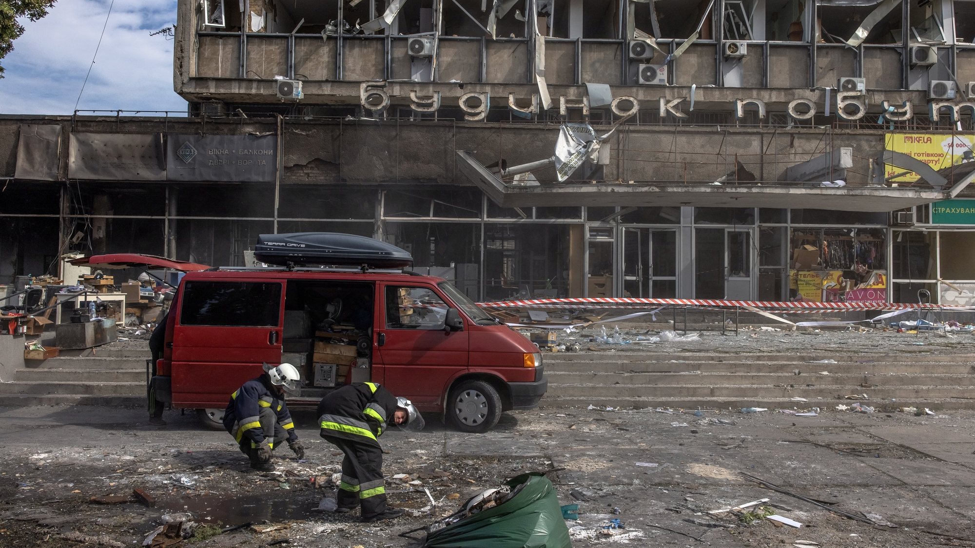epa10072319 Rescue workers in front of a damaged building the day after a Russian missile strike in downtown Vinnytsia, Ukraine, 15 July 2022. At least 23 people were killed and over 70 were injured on 14 July following a missile strike on Vinnytsia, the State Emergency Service of Ukraine confirmed. As of 15 July, 18 people were still missing.  EPA/ROMAN PILIPEY