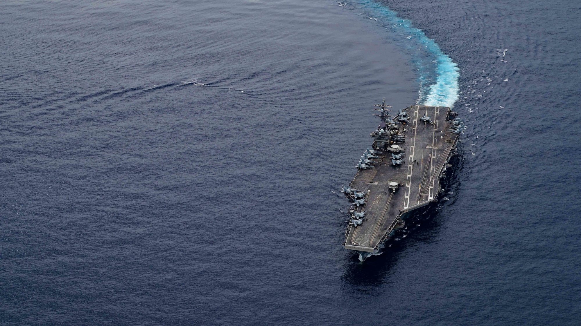 epa08531571 A handout photo made available by the US Navy shows the US Navy’s only forward-deployed aircraft carrier USS Ronald Reagan (CVN 76) steams through international waters while conducting routine flight operations, ensuring Ronald Reagan’s combat proficiency and readiness, in the South China Sea, 04 July 2020 (issued 07 July 2020). The USS Ronald Reagan is the flagship of Carrier Strike Group (CSG) 5. The Nimitz and Ronald Reagan carrier strike groups are conducting dual-carrier operations in the Philippine Sea as the Nimitz Carrier Strike Force.  EPA/Petty Officer 3rd Class Jason Tarleton / HANDOUT  HANDOUT EDITORIAL USE ONLY/NO SALES