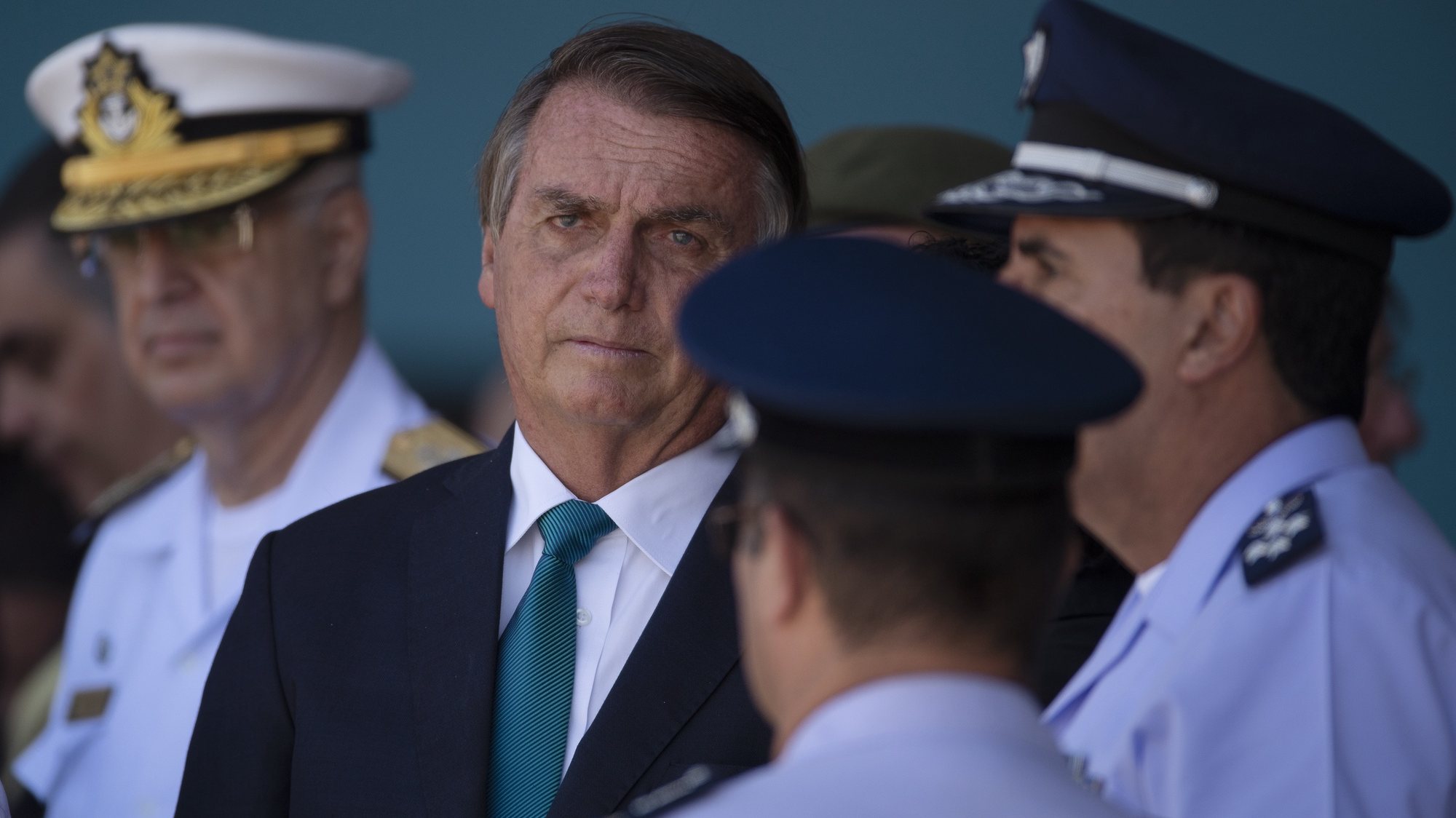 epa09815593 The President of Brazil, Jair Bolsonaro (C), takes part in the reception of Brazilian and other citizens who resided in Ukraine and were rescued in Operation Repatriation, at the Military Air Base of Brasilia, Brazil, 10 March 2022. The President of Brazil, Jair Bolsonaro, received this 10 March a group of 68 people who lived in Ukraine and managed to escape the war and reach Poland, where they were picked up this week by two planes of the Brazilian Air Force (FAB). They are 42 Brazilians, 20 Ukrainians, five Argentines and one Colombian, along with eight dogs and two cats.  EPA/JoÃ©dson Alves