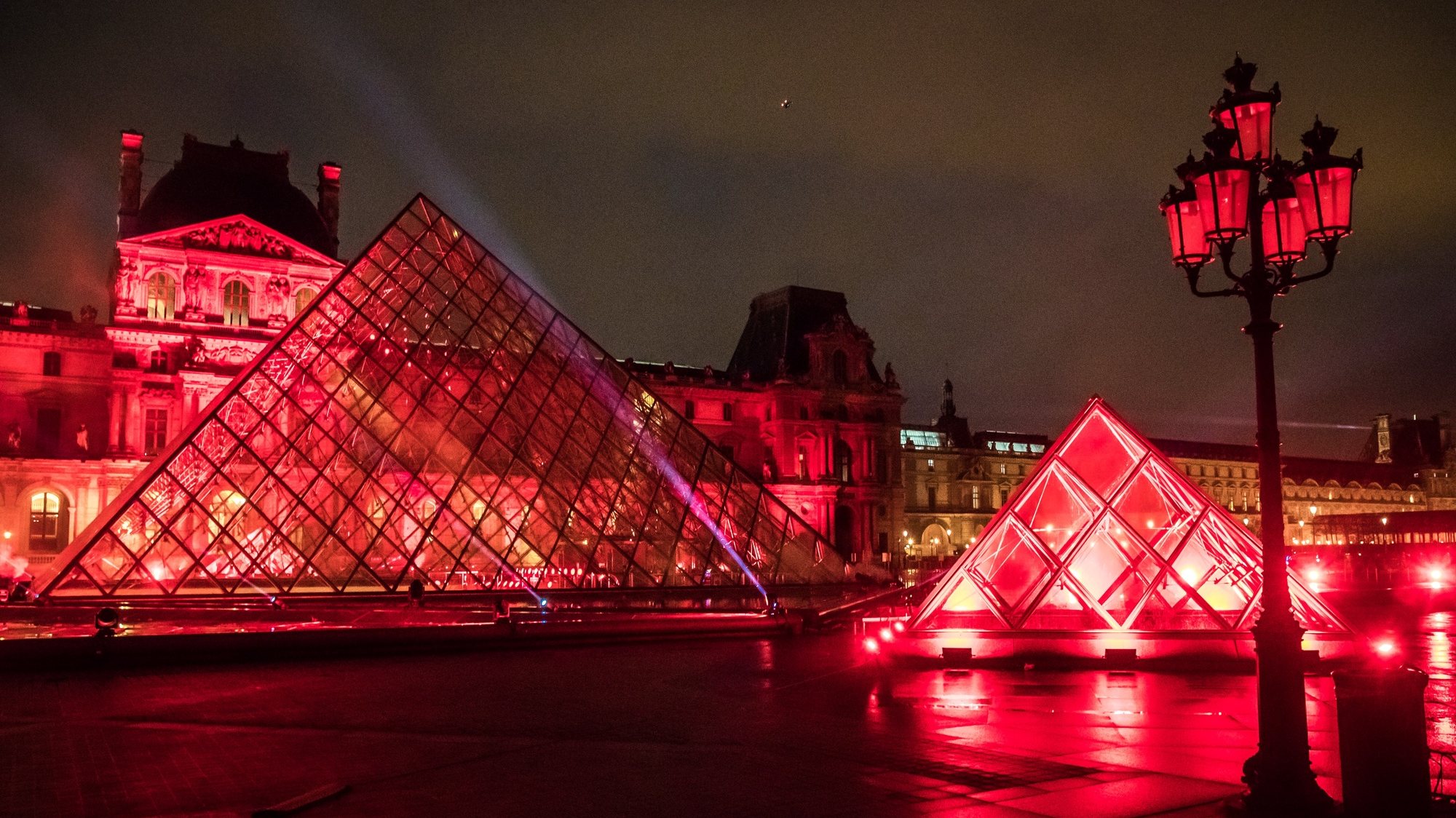 epa08910941 Lights are projected on the Louvre&#039;s Museum Pyramid during the tuning of the performance of the French Dj David Guetta in Paris, 29 December 2020 (issued 30 December 2020). The third edition of the Guetta&#039;s &#039;United at Home&#039; concert will be broadcasted 31 December for the New Year Eve celebration on social media and TV. Due to the still high number of Covid-19 cases, a curfew is imposed between 8 pm and 6 am effective from 15 December 2020 and all the streets gathering or celebrations are cancelled.  EPA/CHRISTOPHE PETIT TESSON