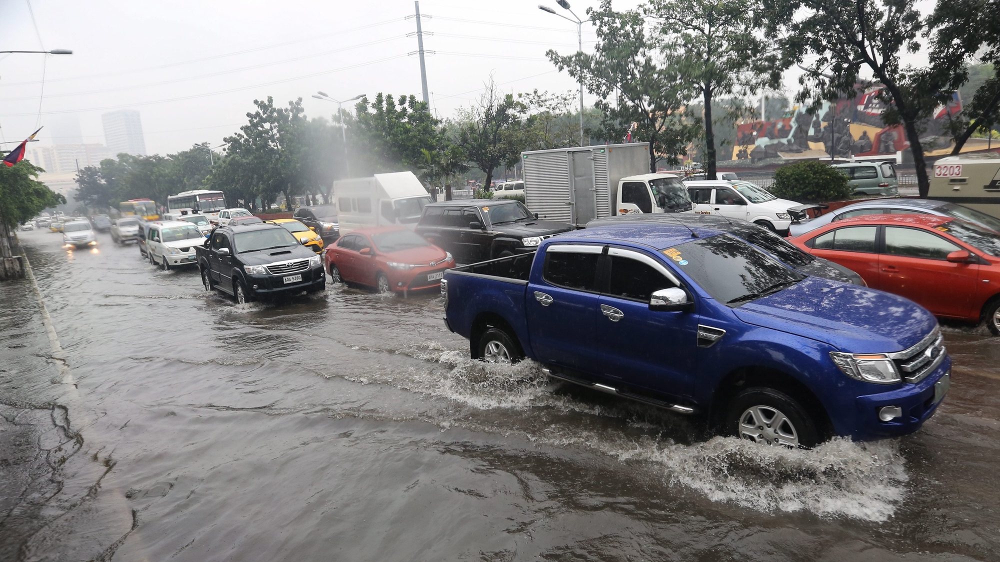 epa05074904 Vehicles make there way along a flooded road during a downpour in Manila, Philippines, 19 December 2015. The Philippines issued a warning against flash floods and landslides in its southern regions as a tropical depression threatened a return of heavy rains Friday. Tropical depression Onyok, the second storm to hit the country in a week, was expected to make landfall in Mindanao later in the day. Onyok, packing sustained winds of 55 kilometres per hour (kph), is expected to weaken into a low-pressure area passing the western Philippines early Sunday.  EPA/MARK R. CRISTINO