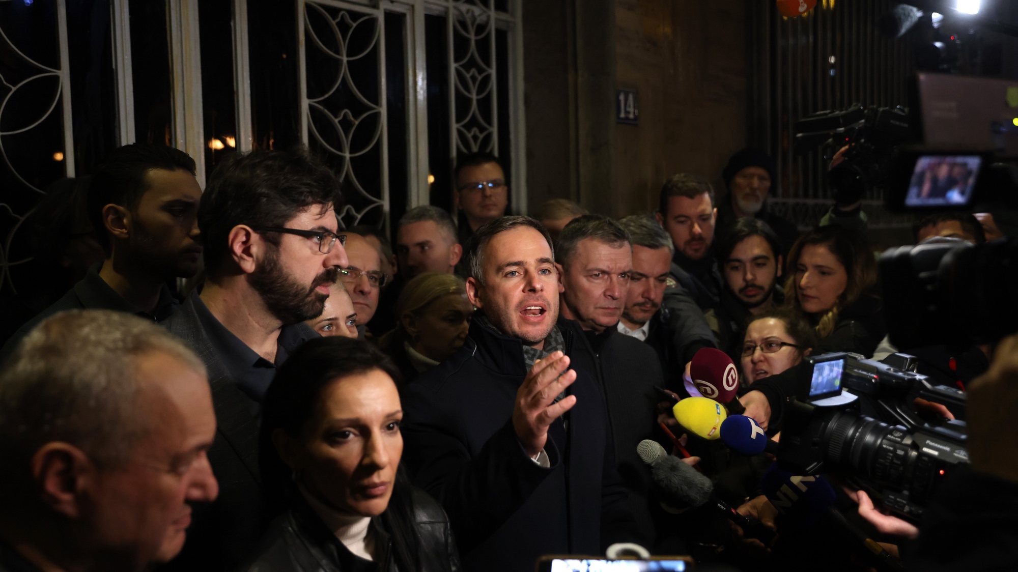 epa11036504 Serbian politician Miroslav Aleksic (C), flanked by other opposition leaders, speaks to members of the media in front of the Serbian Electoral Commission building in Belgrade, Serbia, 18 December 2023. Early official vote count after the Parliamentary and local elections confirmed that the Serbian Progressive Party (SNS) had won the election in Serbia and secured a majority in the Parliament, but tensions grew high after the opposition reported irregularities in the capital of Belgrade and called their supporters to protest at the electoral commission building.  EPA/ANDREJ CUKIC