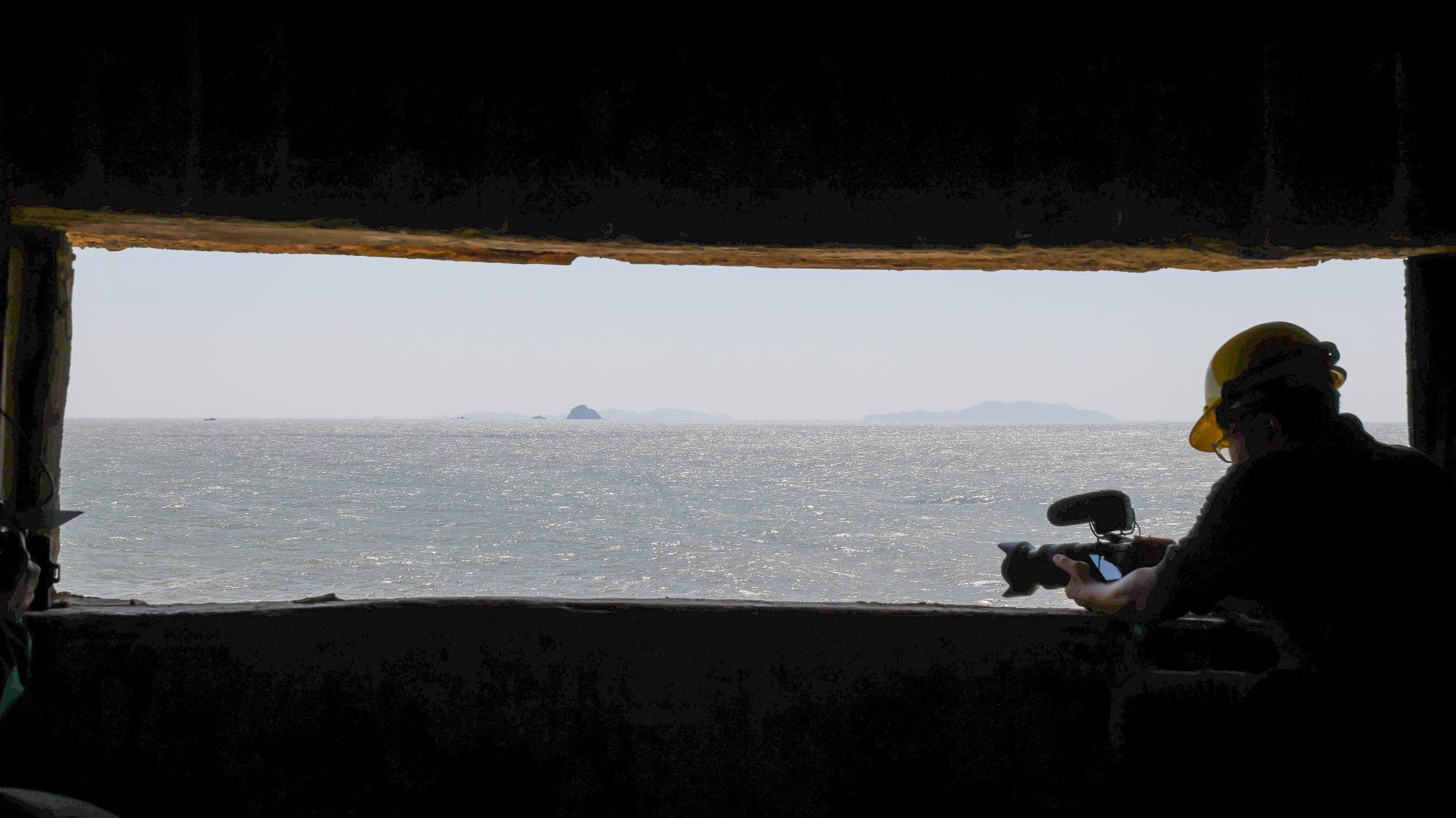 epa10914403 A man film from a window inside one of the 26 old military wartime tunnels during the Matsu Biennial art exhibition in Nangan, Matsu Islands, Taiwan, 12 October 2023. Matsu Biennial showcases local artists&#039; creative perspectives on the island through an &#039;island perspective&#039; project at Chungshan Gate on Nangan Island. The exhibition, reinterpreted as an arts and culture venue, aims to launch Matsu&#039;s arts and culture internationally, marking the first significant exhibition since Chungshan Gate&#039;s transformation. The Matsu Islands, a group of 36 islands in the East China Sea, are the smallest county in Taiwan.  EPA/RITCHIE B. TONGO