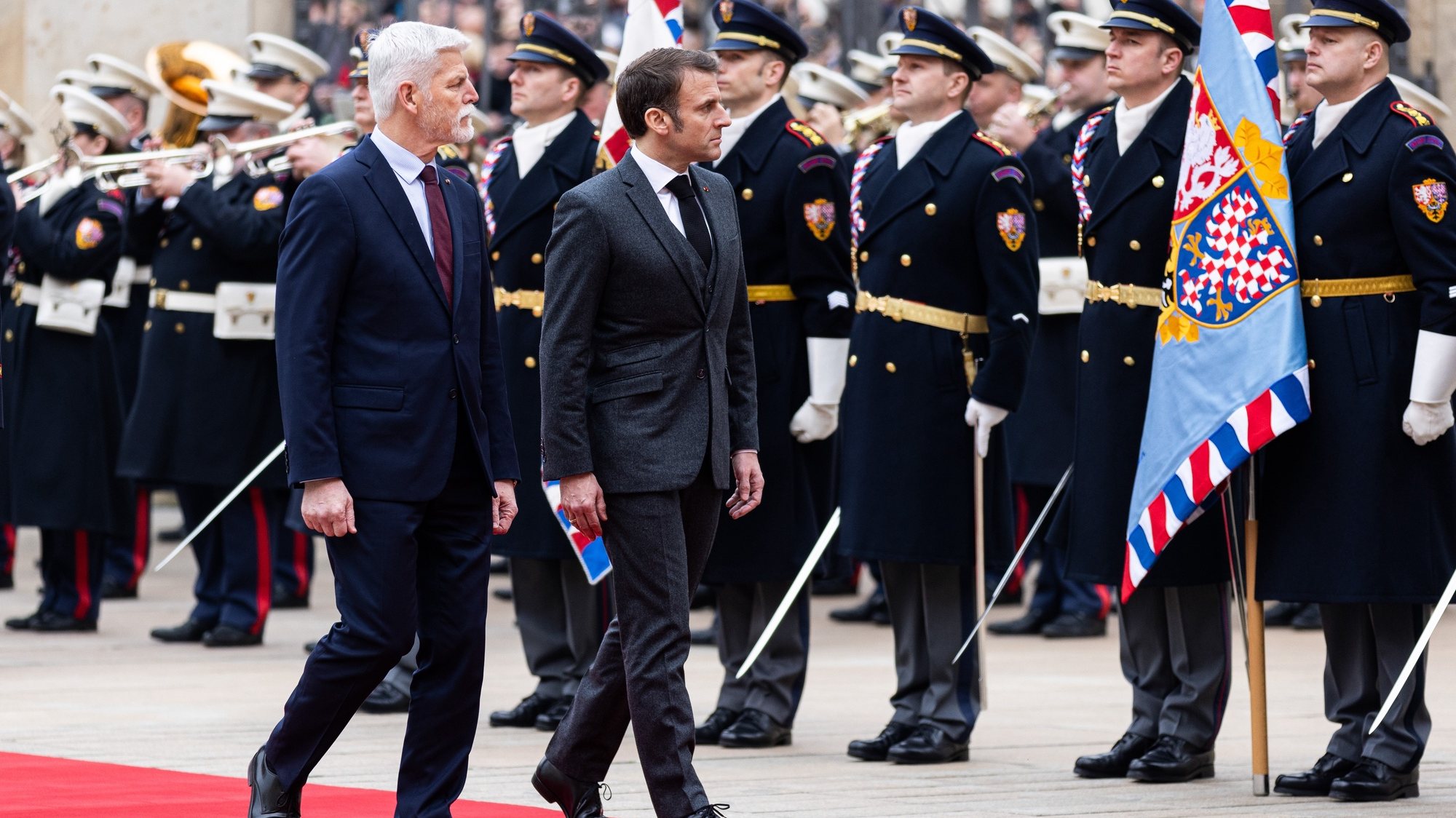 epa11199950 Czech President Petr Pavel (L) and French President Emmanuel Macron (R) inspect guards of honor during a welcome ceremony at Prague Castle in Prague, Czech Republic, 05 March 2024. Macron is on an offcial visit to Prague.  EPA/MICHAL TUREK
