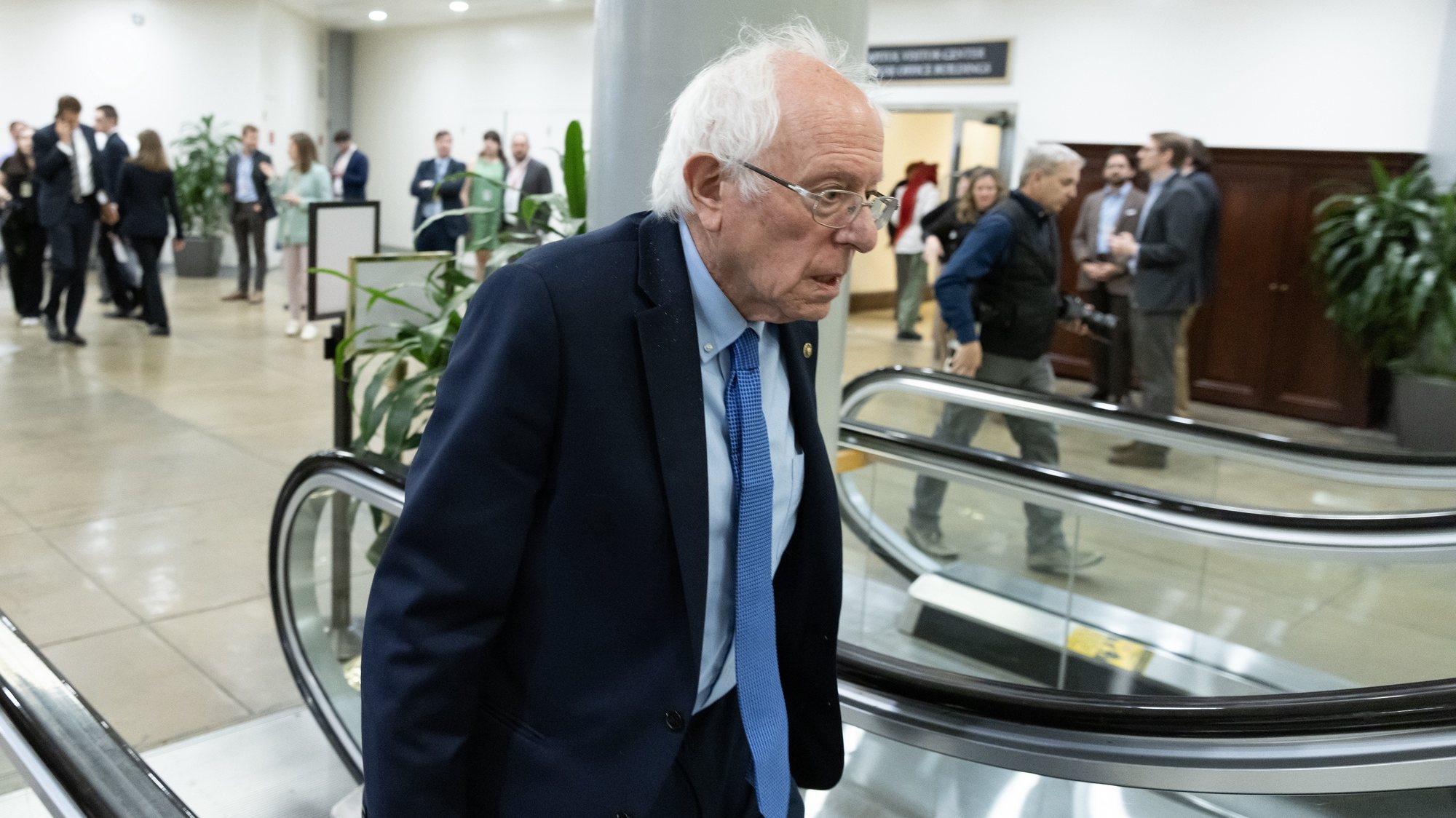 epa11296462 Independent Senator of Vermont Bernie Sanders takes an escalator near the Senate subway during a Senate procedural vote on the national security supplemental, on Capitol Hill in Washington, DC, USA, 23 April 2024. The Senate advanced the national security supplemental with aid to Israel, Ukraine and Taiwan.  EPA/MICHAEL REYNOLDS