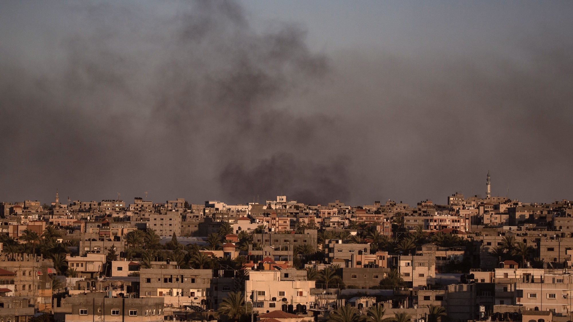 epa11367088 Smoke rises after an Israeli airstrike in Rafah, southern Gaza Strip, 24 May 2024. The International Court of Justice (ICJ) on 24 May ordered Israel to halt its military operation in Rafah, to open the Rafah border crossing with Egypt to allow for the entry of humanitarian aid, to allow access to Gaza for investigators, and to report to the court within one month on its progress. More than 35,000 Palestinians and over 1,400 Israelis have been killed, according to the Palestinian Health Ministry and the Israel Defense Forces (IDF), since Hamas militants launched an attack against Israel from the Gaza Strip on 07 October 2023, and the Israeli operations in Gaza and the West Bank which followed it.  EPA/HAITHAM IMAD