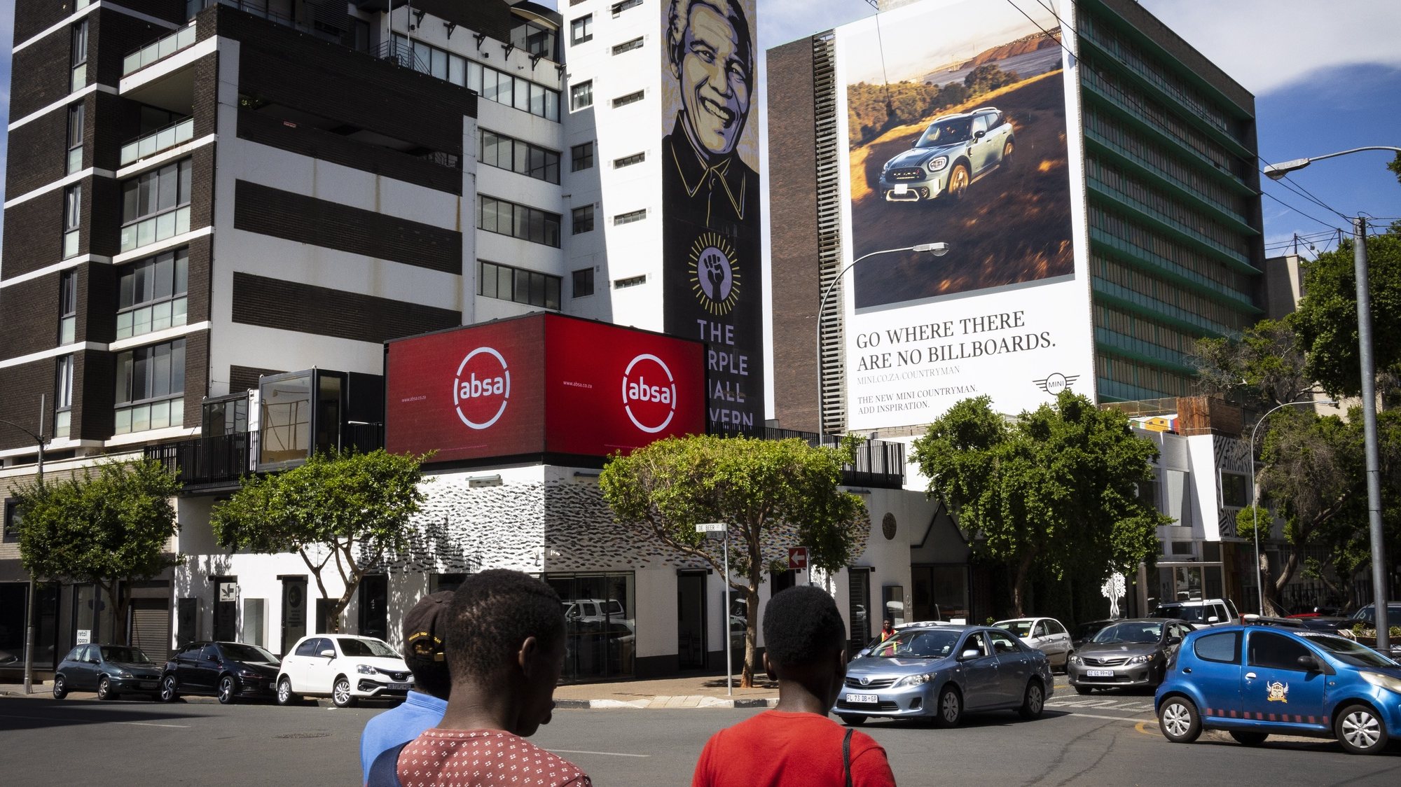 epa08873871 Pedestrians walk past bank and car dealership advertising in downtown Johannesburg, South Africa, 10 December 2020. Data from STATS SA, the national statistical service of South Africa, revealed that the economy has grown since the relaxing of Covid-19 Corona virus lockdown, with a GDP growth recording 13.5 percent in the third quarter of the year. This was recorded despite the harsh level 5 national lockdown that virtually closed the country&#039;s economy for months.  EPA/KIM LUDBROOK