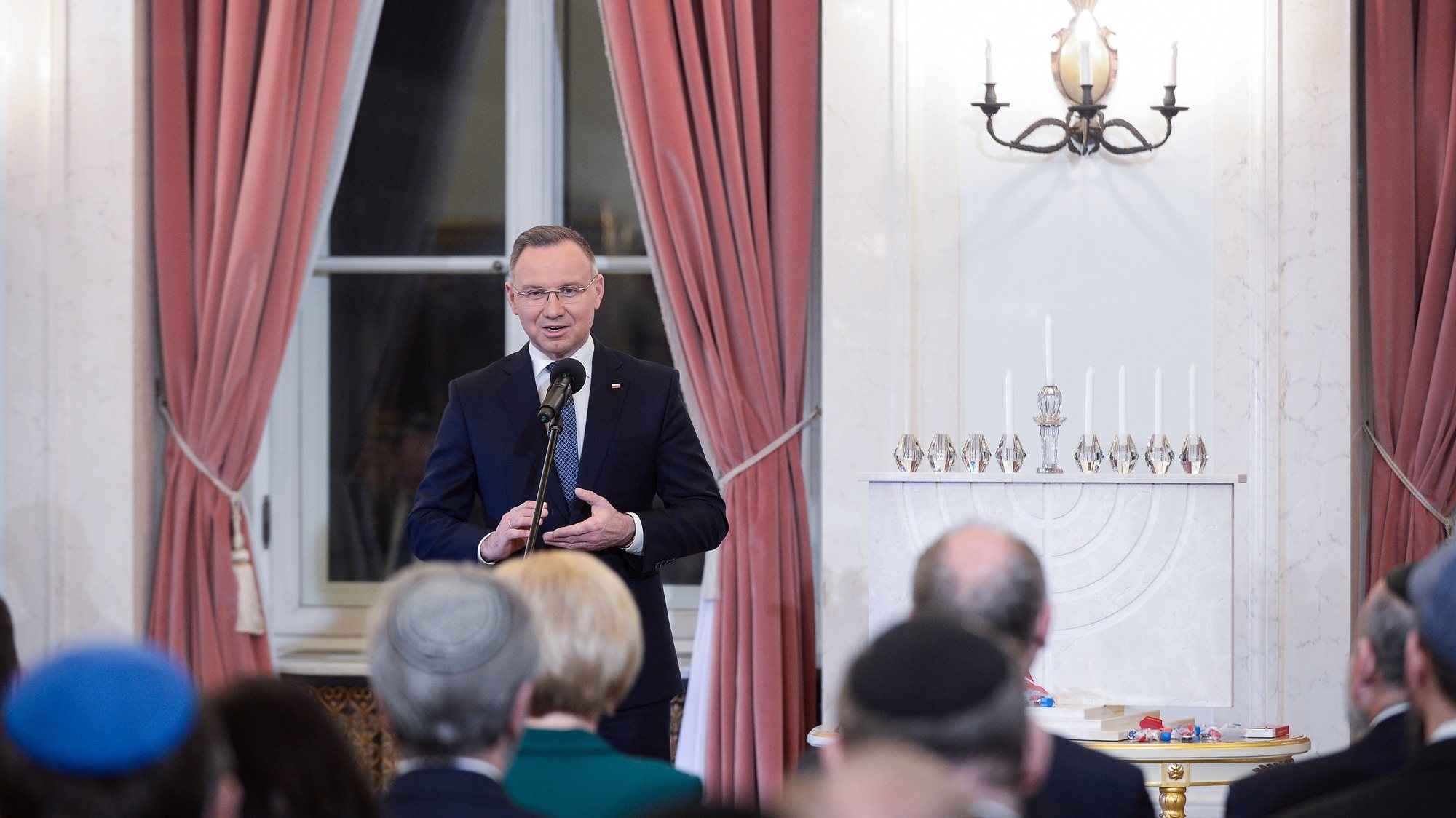 epa11023170 Polish President Andrzej Duda speaks during the ceremony of lighting the candles on the traditional Jewish feast of Hanukkah at the Presidential Palace in Warsaw, Poland, 11 December 2023. The Hanukkah menorah was lit to mark the start of the Jewish Hanukkah holiday and symbolize the victory of light over darkness.  EPA/Marcin Obara POLAND OUT