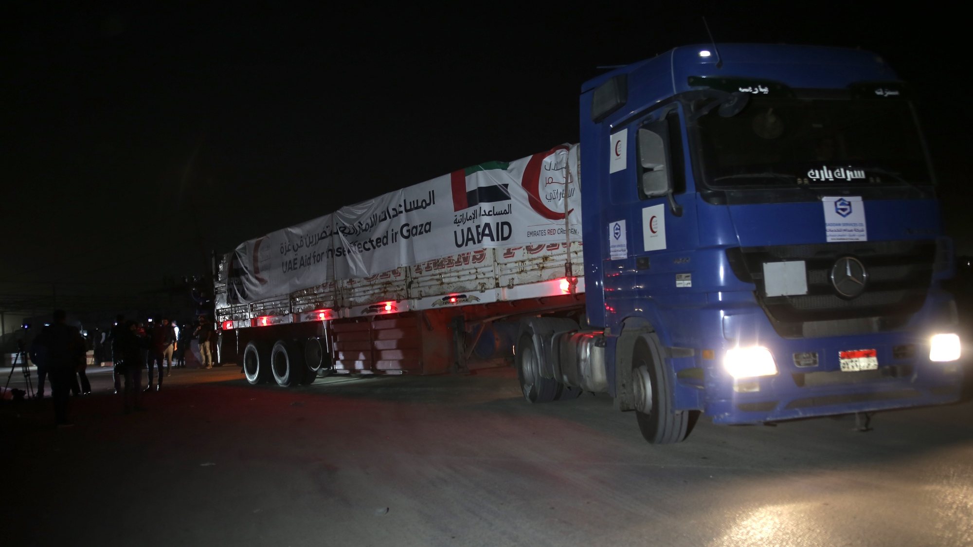 epa10996782 Trucks carrying medical aid from the Emirates Red Crescent enter Gaza through the Rafah crossing in the southern Gaza Strip, 26 November 2023. Israel and Hamas had agreed to a four-day ceasefire mediated by Qatar, the USA, and Egypt, that came into effect on 24 November and includes a deal for the release of people held by Hamas in the Gaza Strip in exchange for Palestinians detained in Israeli prisons.  EPA/HAITHAM IMAD