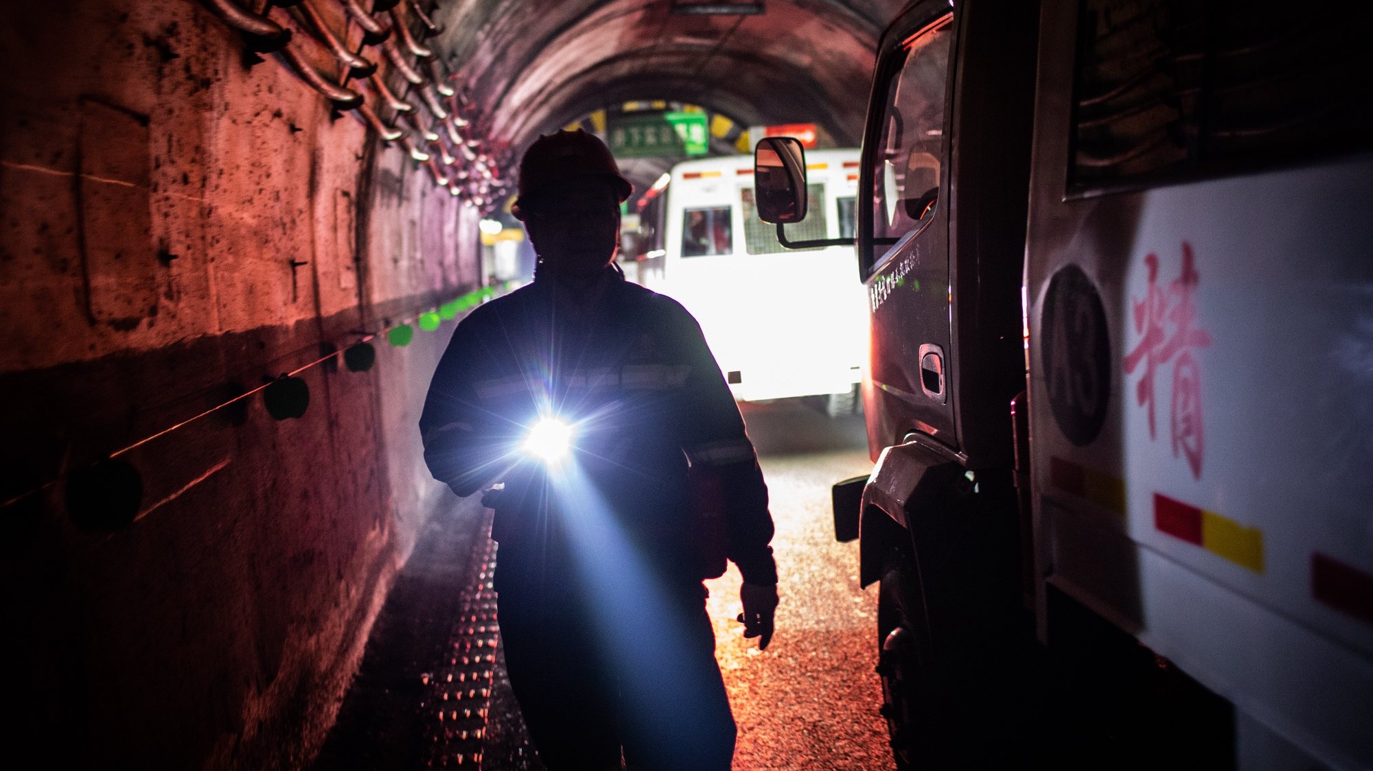 epa07061733 A coal miner walks in the tunnel which leads to a training area and the coal mine of Huangling Mining, in Diantou, Shaanxi Province, China, 29 September 2018 (issued 01 October 2018). Huangling Mining has four mines with a total output of 16 million tons of coal. China is the largest consumer and producer of coal in the world and is considered the largest user of coal-derived electricity.  EPA/ROMAN PILIPEY