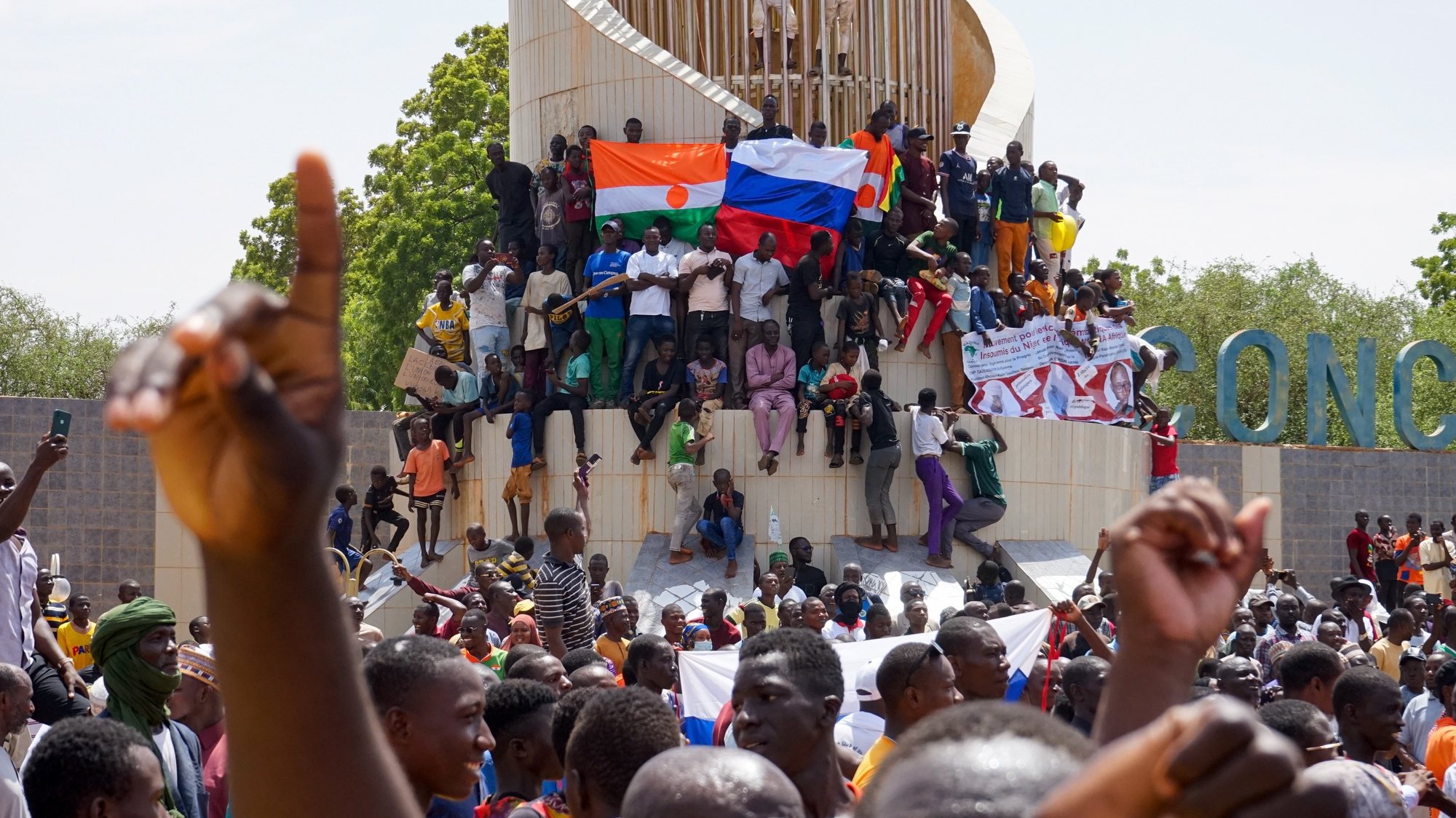 epaselect epa10777357 People display a Russia and a Niger flags outside the National Assembly building during a protest in Niamey, Niger, 30 July 2023. Thousands of supporters of General Abdourahamane Tchiani, head of the Presidential Guard, who declared himself the new leader of Niger after a coup against democratically elected President Mohamed Bazoum on 26 July, took to the streets of Niamey to demonstrate support for the coup.  EPA/ISSIFOU DJIBO