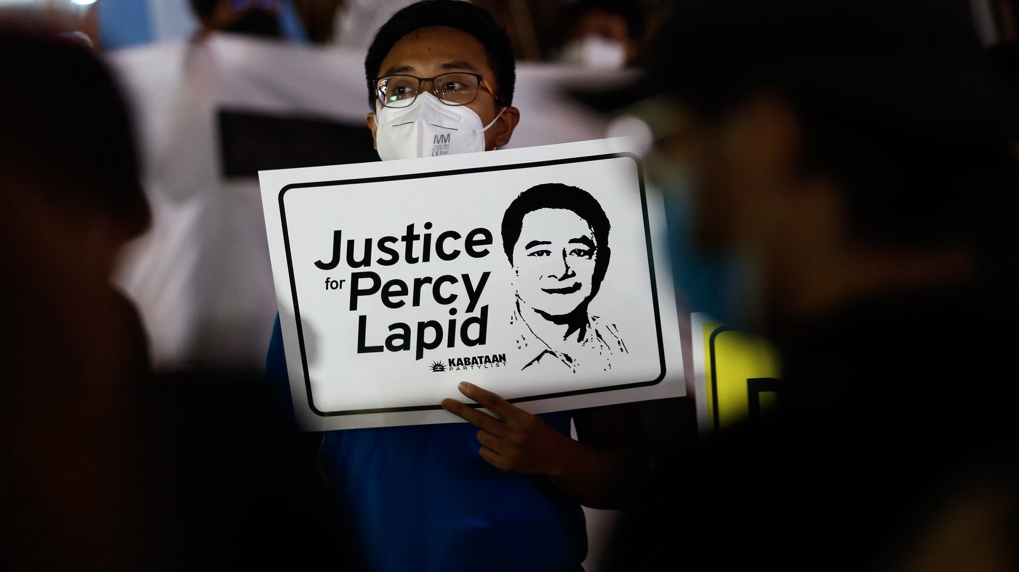 epa10222813 A protester holds a sign with an image of slain broadcast journalist Percy Mabasa, also known as Percy Lapid, during an indignation rally against members of the media&#039;s killings in Quezon City, Metro Manila, Philippines, 04 October 2022. A rally was held by human rights advocates and members of journalist organizations to demand government action and condemn the killing of broadcast journalist Percival Mabasa, also known as Percy Lapid, who was shot dead by unidentified assailants on 03 October while on his way to work in Las Pinas City, according to latest police reports.  EPA/ROLEX DELA PENA