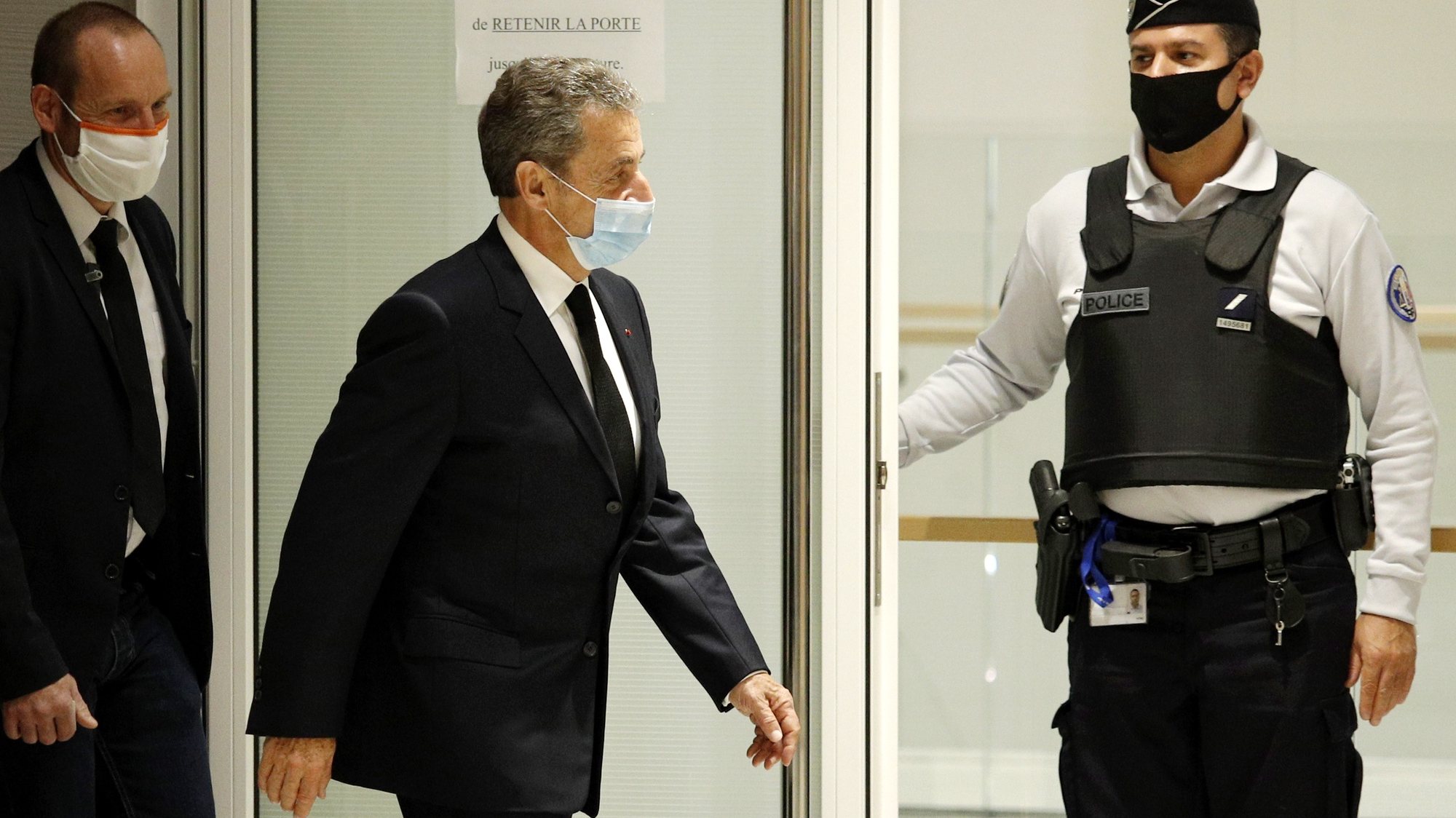 epa08843475 Former French president Nicolas Sarkozy (C) leaves the courtroom during his trial on corruption charges in the so-called &#039;wiretapping affair&#039; in Paris, France, 26 November 2020. In 2013, Nicolas Sarkozy was using a false name, Paul Bismuth, to make phone calls to call his lawyer, Thierry Herzog, about the decision that the Court of Cassation was about to take regarding the seizure of presidential diaries in a separate case. The trial is due to run from 23 November to 10 December.  EPA/YOAN VALAT *** Local Caption *** 55512057