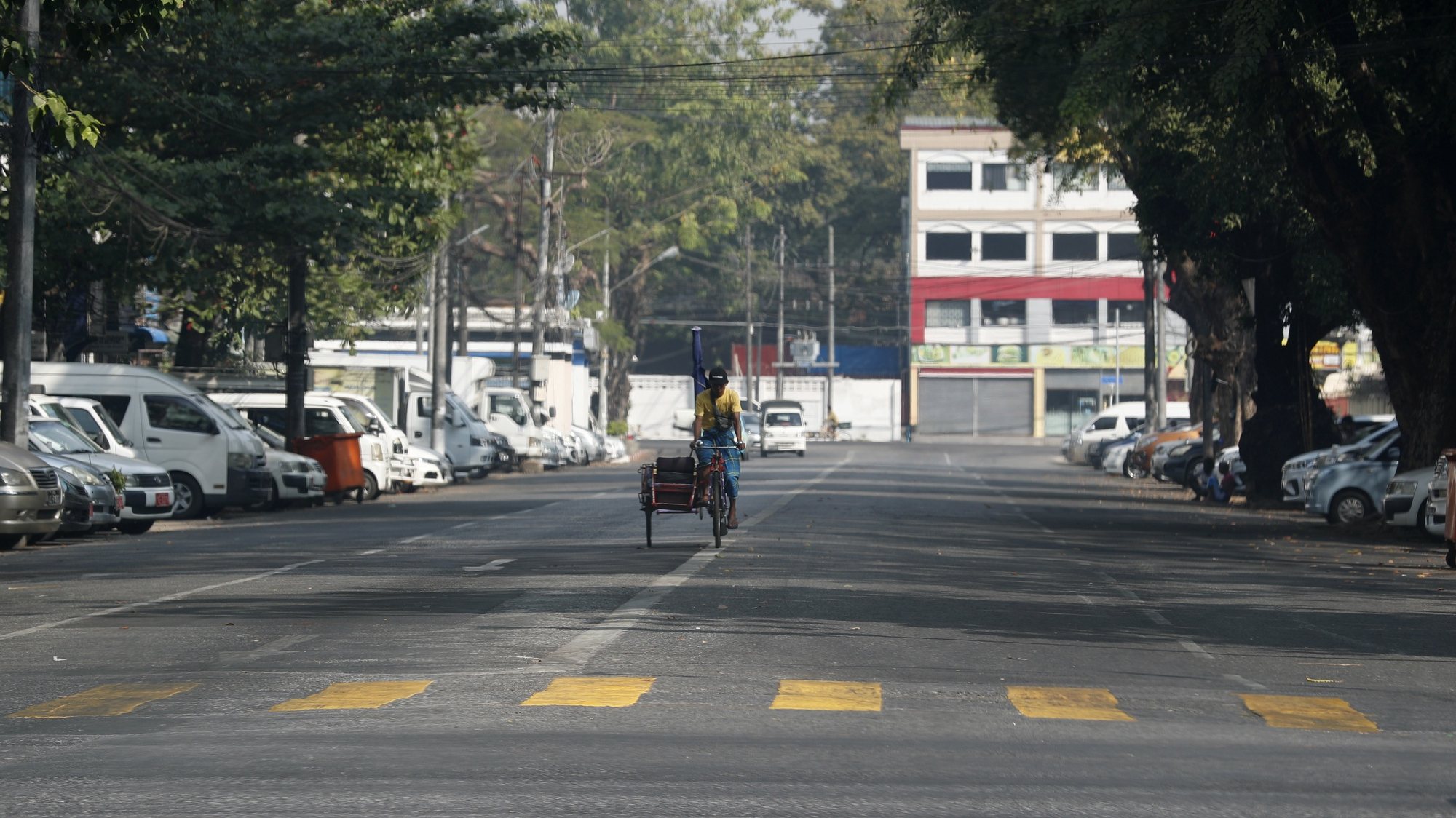 epa10442095 A trishaw rides on an empty road in downtown Yangon, Myanmar, 01 February 2023. Anti-coup groups called for the public to participate in the Silent Strike to protest against the military coup, by staying at home from 10 am to 3 pm on 01 February 2023.  EPA/STRINGER