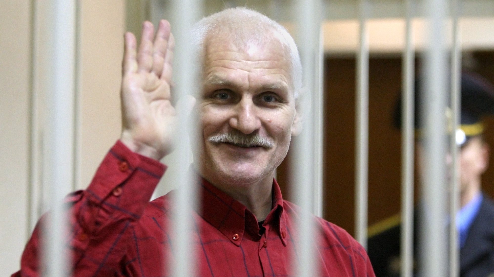 epa10228762 (FILE) - Belarusian human rights activist Ales Bialiatski (also transliterated as Alex Belyatsky), leader of Viasna, a human rights group based in Minsk, waves as he waits in a trial cage inside a courtroom prior to a court session in Minsk, Belarus, 24 November 2011 (reissued 07 October 2022). The Nobel Peace Prize 2022 has been awarded to human rights advocate Ales Bialiatski from Belarus, the Russian human rights organization Memorial and the Ukrainian human rights organization Center for Civil Liberties. The Norwegian Nobel Committee said in a statement that by awarding the Nobel Peace Prize for 2022 to Bialiatski, Memorial and the Center for Civil Liberties, it wishes to &#039;honour three outstanding champions of human rights, democracy and peaceful co-existence in the neighbour countries Belarus, Russia and Ukraine.&#039; Bialiatski was imprisoned from 2011 to 2014 and following large-scale demonstrations against the Belarus regime in 2020, he was again arrested and still detained without trial, the Norwegian Nobel Committee added.  EPA/TATYANA ZENKOVICH *** Local Caption *** 50100352