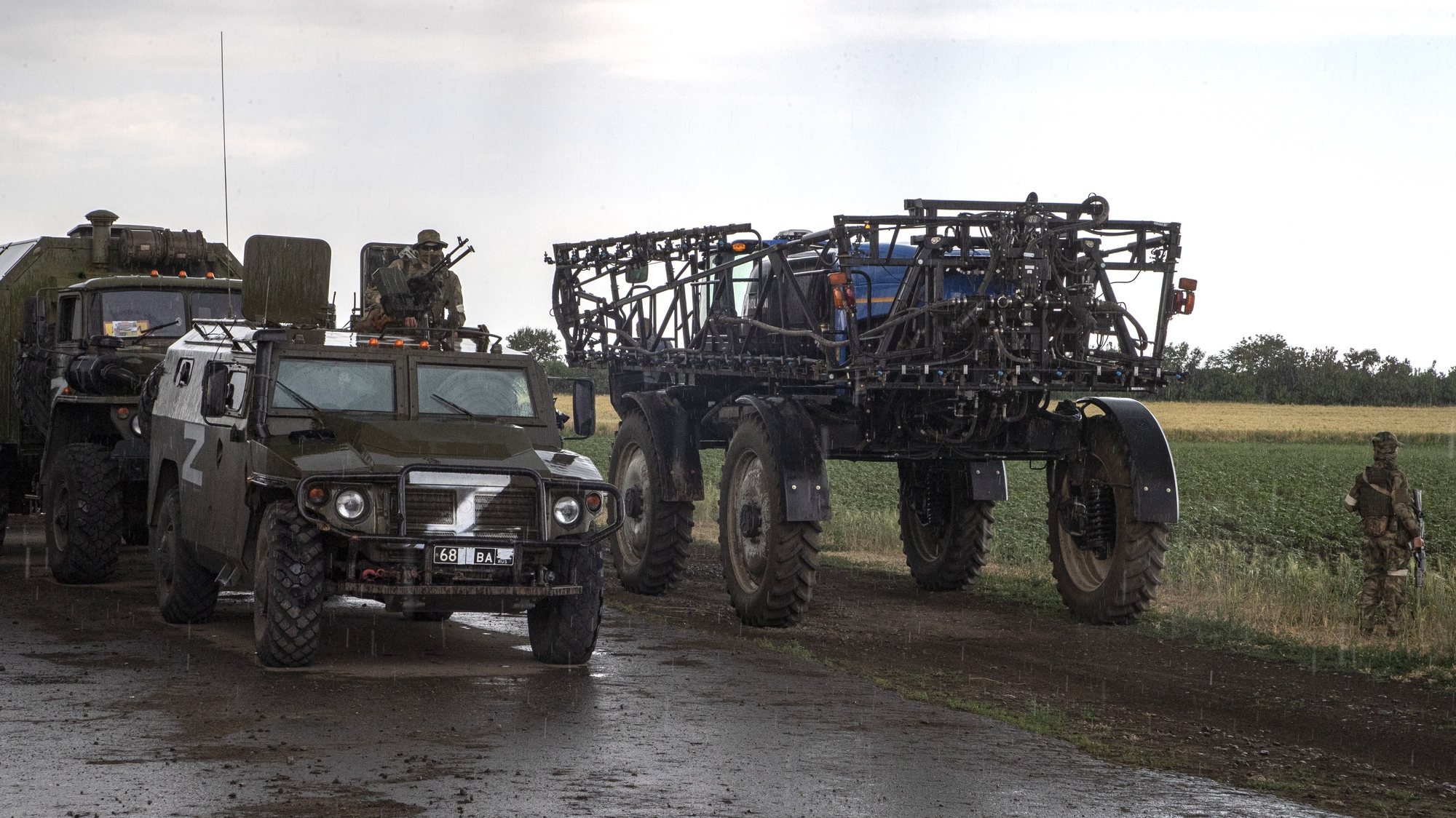 epa10013938 Russian servicemen and their vehicles seen near an agricultural tractor in front of a wheat field near Melitopol, Zaporizhia region, Ukraine, 14 June 2022 (Issued on 15 June 2022). The conflict in Ukraine has affected the availability and price of wheat worldwide. The Food and Agriculture Organization (FAO) of the United Nations said in its 10 June note assessing the risks emanating from the conflict in Ukraine that &#039;the current war raises concerns over whether crops will be harvested. It has already led to the closures of ports and oilseed crushing operations, affecting products intended for the export markets&#039;. These are taking a toll on the country&#039;s exports of grains and vegetable oils. The city of Melitopol is located on the territory controlled by the troops of the Russian Federation and the city is administered by the Military-Civilian Administration controlled by Russia. On 24 February 2022 Russian troops entered the Ukrainian territory in what the Russian president declared a &#039;Special Military Operation&#039;, starting an armed conflict that has provoked destruction and a humanitarian crisis.  EPA/SERGEI ILNITSKY