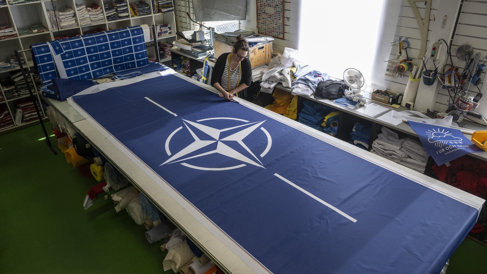epaselect epa11204068 Seamstress Tove Lycke at work with new NATO flags, at the flag manufacturer &#039;Flagghuset&#039;, in Akersberga, outside Stockholm, Sweden, 07 March 2024. At the family business in Akersberga, printing the blue NATO flag is in full swing ahead of Sweden&#039;s accession to NATO, as municipalities, authorities and businesses want to be ready to raise the new flag. Hungary’s president ratified Stockholm’s accession documents on 05 March, paving the way for the accession of the Nordic country to the alliance.  EPA/Anders Wiklund SWEDEN OUT