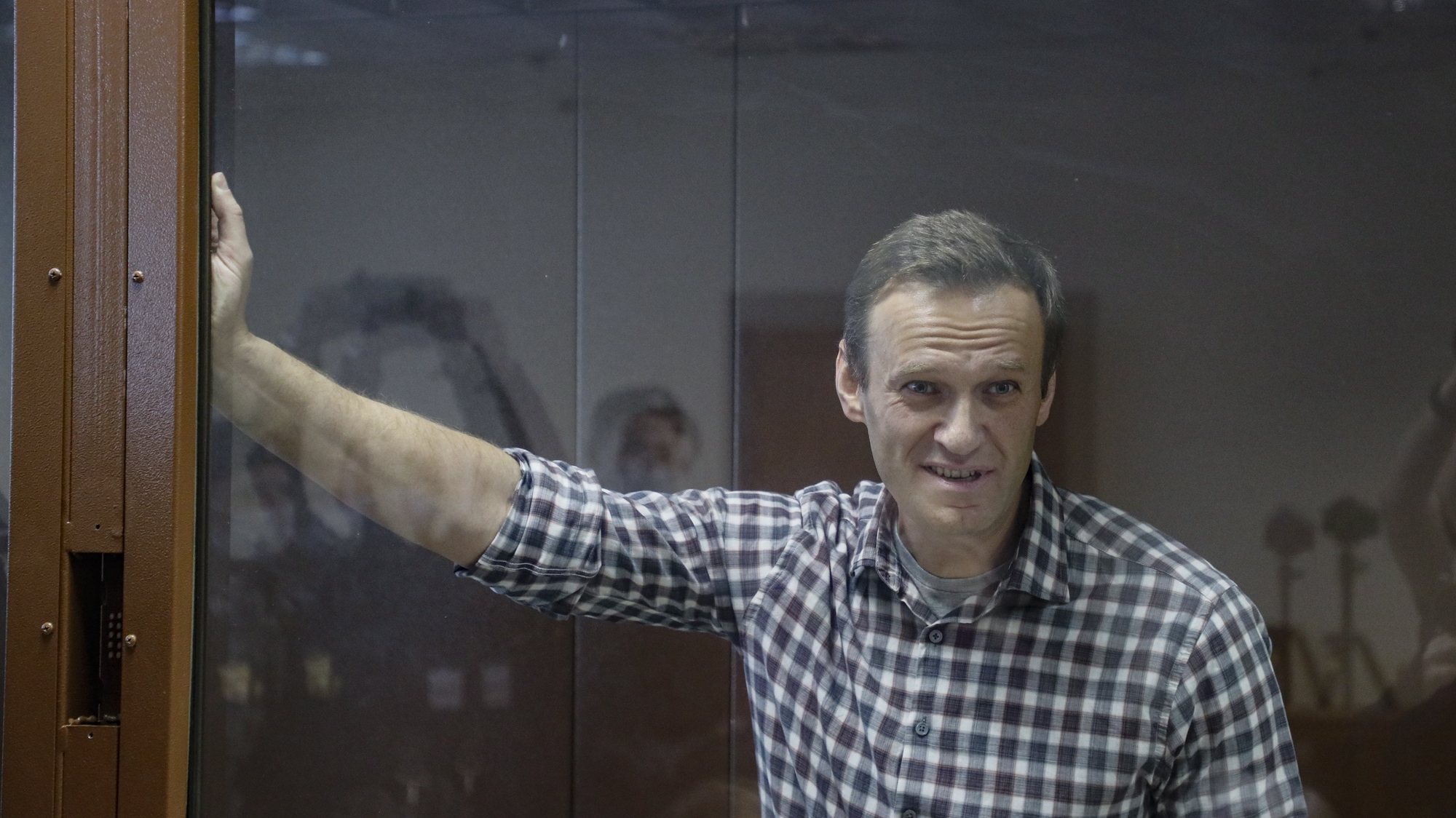 epa09025238 Russian opposition leader Alexei Navalny stands inside a glass cage prior to a hearing at the Babushkinsky District Court in Moscow, Russia, 20 February 2021. The Moscow City court will hold a visiting session at the Babushkinsky District Court Building to consider Navalny&#039;s lawyers appeal against a court verdict issued on 02 February 2021, to replace the suspended sentence issued to Navalny in the Yves Rocher embezzlement case with an actual term in a penal colony.  EPA/YURI KOCHETKOV MANDATORY CREDIT