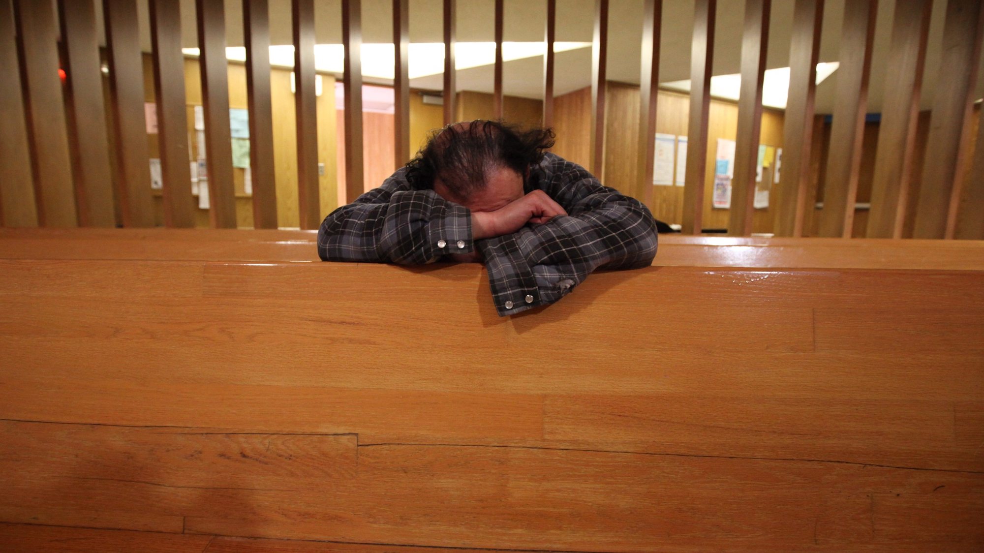 epa02019844 A homeless man sleeps leaning on a church pew offered as emergency beds in the First United Church, in the city&#039;s Eastside, not far from the Athletes Village and only five blocks away from the site of the opening ceremony for the 2010 Vancouver Winter Olympics, in Vancouver, Canada, 06 February 2010. Canada&#039;s third biggest city Vancouver will host the 2010 Winter Olympic Games from February 12 - 28. But for most of the many homeless in this area, and the groups trying to help them with drug addiction and mental health issues, the amount of money spent  in hosting the 2010 Winter Olympics could have been better allocated on homes for the needy. The Church sleeps 300 people and offers donated meals for 200 and more, depending on food donations.  EPA/BARBARA WALTON