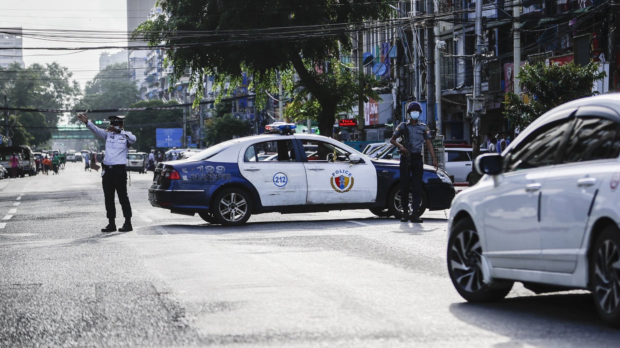 epa09408105 A traffic police gestures as the police patrol blocks a main road after several explosions occurred at downtown area in Yangon, Myanmar, 10 August 2021. Reports indicate at least five explosions occurred in the afternoon of 10 August. No casualties or injuries reported by authority.  EPA/STRINGER