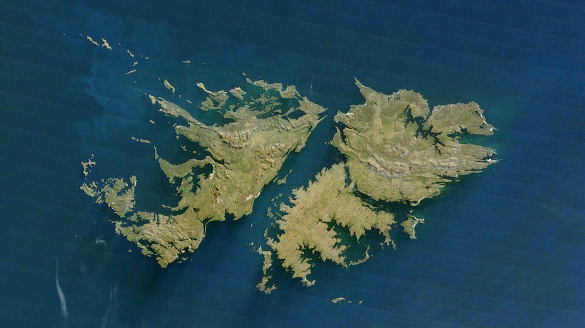 This NASA Terra satellite released 14 July, 2003 shows the Falkland Islands.The Falklands are a small group of islands 480 kilometers (about 300 miles) east of the Strait of Magellan (the straight crossing the southern point of South America). The two main islands are East Falkland and West Falkland, though some 200 small islands are also part of this British-administered colony. The islands are rocky, wet, and windswept, but are ideally suited for sheep-raising. The waters surrounding the islands are home to great whale and seal populations, and were hunted heavily in the not-too-distant past. Fish are also abundant, and besides sheep, the fishing trade is one of the mainstays of this distant island&#039;s economy. AFP PHOTO/NASA