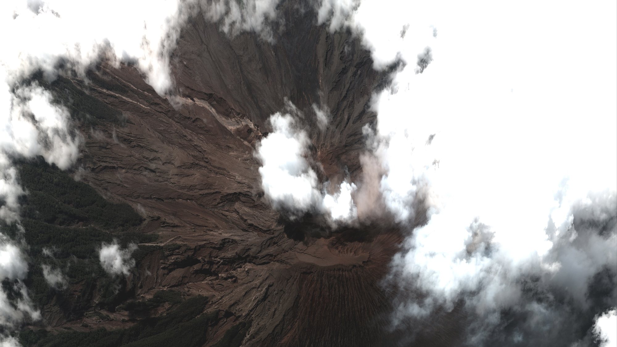 epa09632151 A handout satellite image made available by Maxar Technologies shows the summit of Mount Semeru volcano in East Java, Indonesia, 08 December 2021 (issued 09 December 2021). The volcano erupted on 04 December leaving at least 34 people dead and dozens missing.  EPA/MAXAR TECHNOLOGIES HANDOUT -- MANDATORY CREDIT: SATELLITE IMAGE 2021 MAXAR TECHNOLOGIES -- the watermark may not be removed/cropped -- HANDOUT EDITORIAL USE ONLY/NO SALES