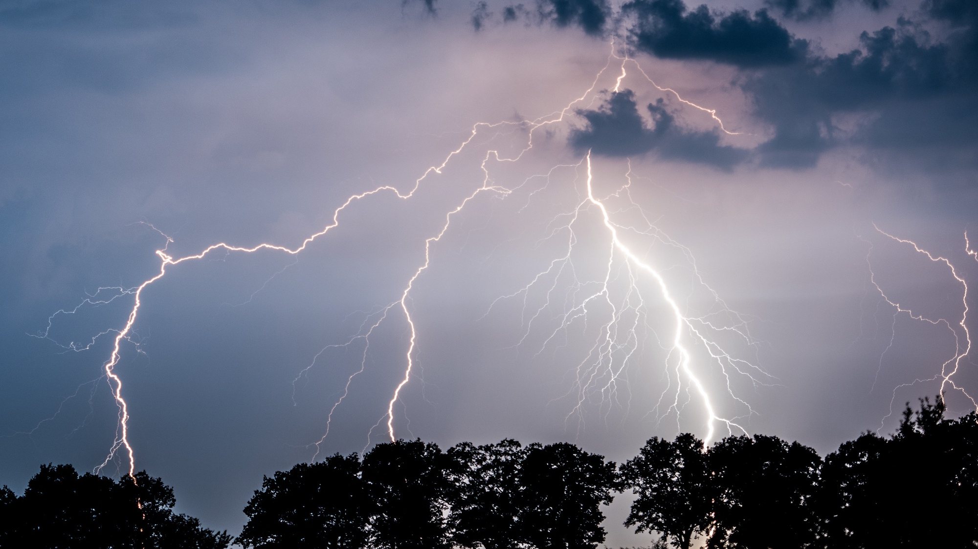epa07655088 (FILE) Lightning illuminates the nigh sky over Landkreis Oder-Spree in Jacobsdorf, Brandenburg, Germany 01 September 2015 (issued 18 June 2019). German forecasters have issued severe weather warnings for the Corpus Christi bank holiday 20 June 2019 with heavy thunderstorms expected across the country.  EPA/PATRICK PLEUL *** Local Caption *** 52174756