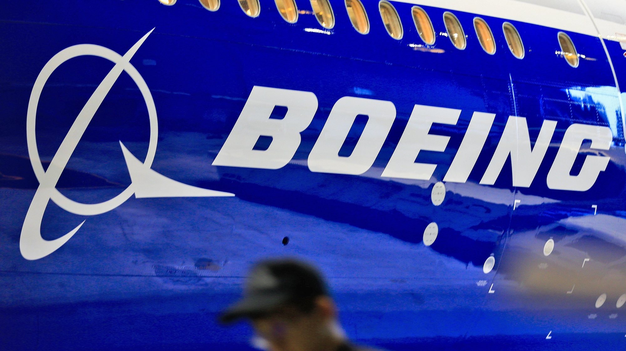 epa08368684 (FILE) - A file photo dated 14 June 2016 showing a man walking past a logo of US aircraft manufacturing company Boeing at Taoyuan airport, in Taoyuan, Taiwan (reissued 17 April 2020). Reports on 17 April 2020 state the Boeing Chief Executive Dave Calhoun told company staff Boeing would restart the production of the 747, 767, and 777 commercial airplanes at their Puget sound facilities in the Washington state on 20 April.  EPA/RITCHIE B. TONGO *** Local Caption *** 53278185