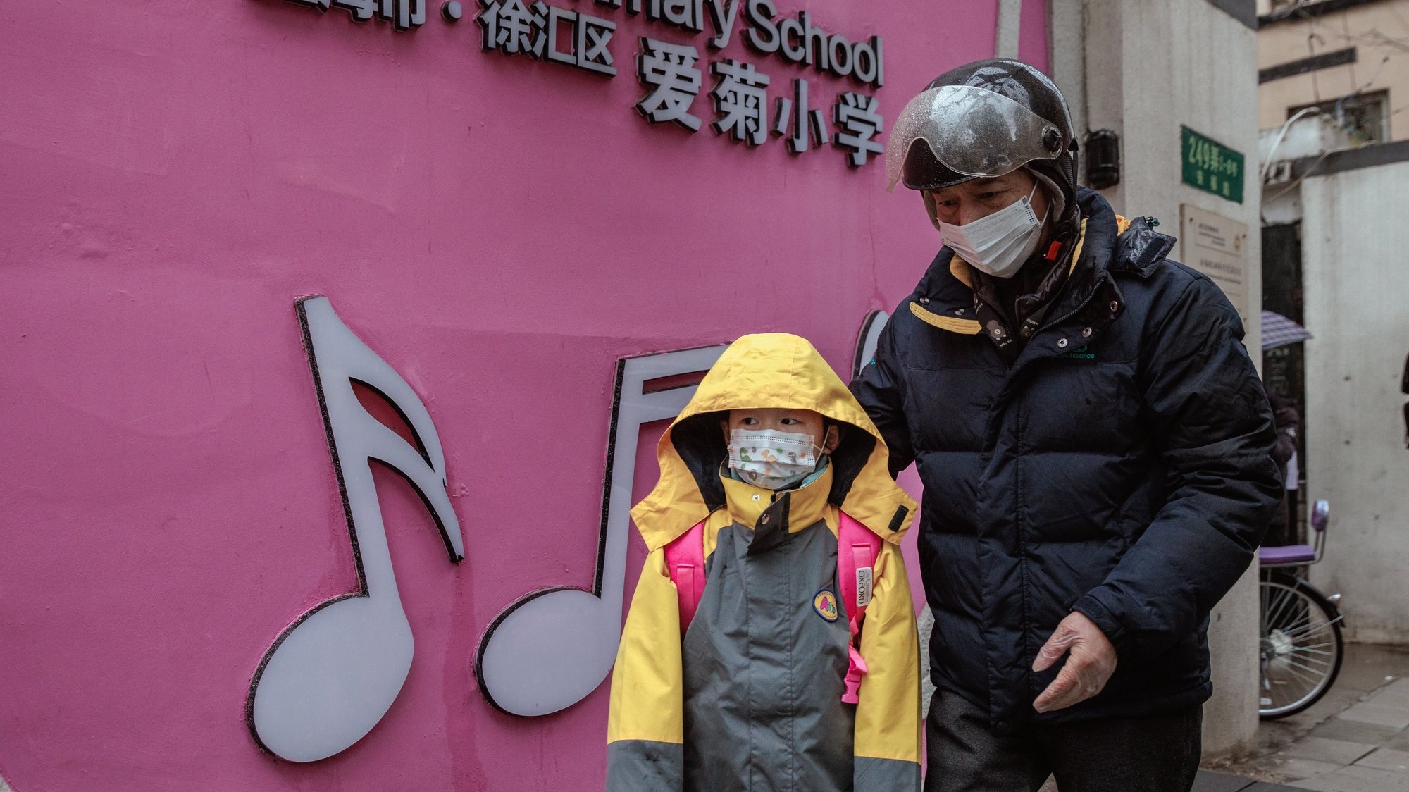 epa10464283 A child escorted by a parent enters their school in Shanghai, China, 13 February 2023. After the Chinese New Year holiday and online classes for three years, students in China are back on campuses. According to the latest guidebook on epidemic prevention and control, schools can restore on-site teaching if there are no COVID-19 cases. Students and school personnel will undergo seven days of health monitoring and minimise gatherings.  EPA/ALEX PLAVEVSKI