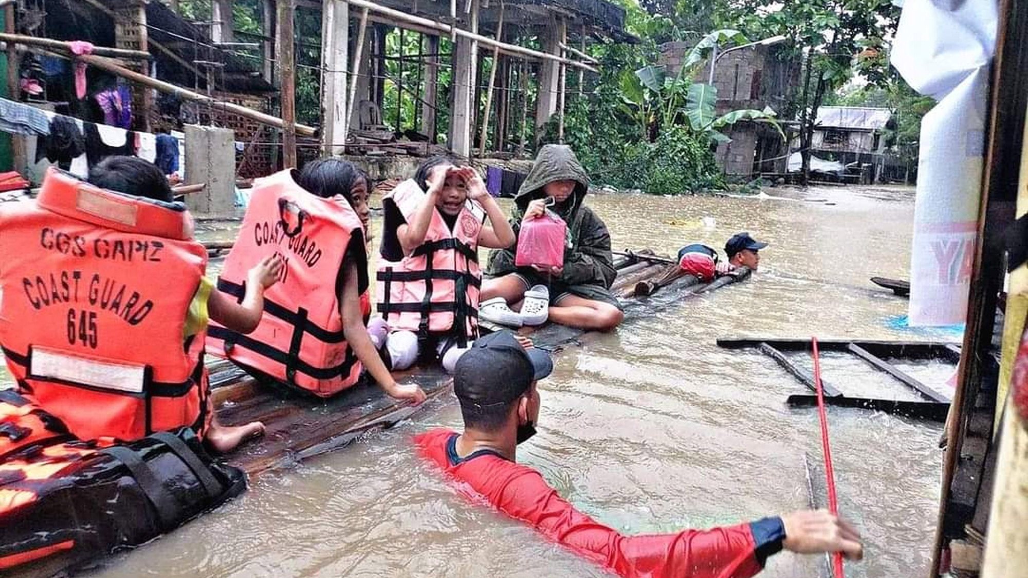 epa09885295 A handout photo made available by the Philippine Coast Guard (PCG) shows rescuers assist villagers in a raft in a flooded village in Panitan, Panay island, Philippines, 12 April 2022. According to local authorities reports, scores of villagers were burried from landslides in the central and southern Philippines brought by Typhoon Megi.  EPA/PCG / HANDOUT BEST QUALITY AVAILABLE HANDOUT EDITORIAL USE ONLY/NO SALES