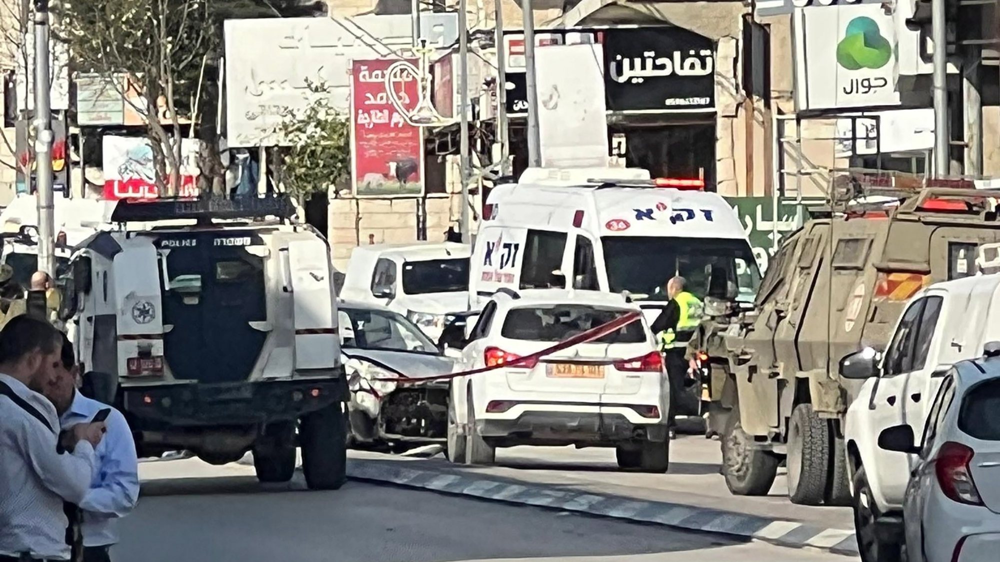 epa10492160 Israeli forces at the scene after a shooting attack in the West Bank town of Hawara, near the city of Nablus, 26 February 2023. The Israeli Defense Forces (IDF) said on 26 February that they blocked the area after an attacker opened fire toward an Israeli vehicle. As a result, two Israeli civilians were injured and evacuated to a hospital for further medical attention, the statement added.  EPA/STRINGER -- BEST QUALITY AVAILABLE