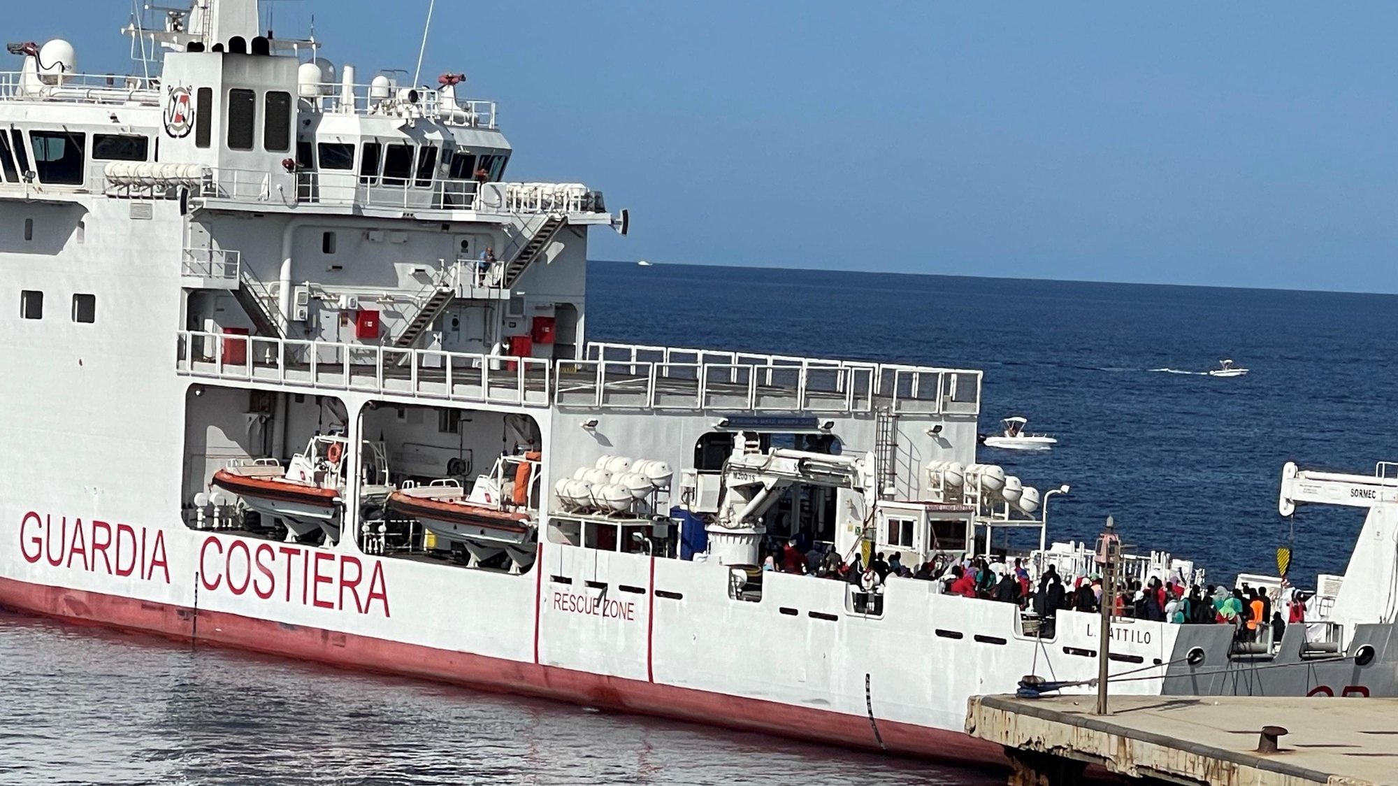 epa10747714 The Italian Coast Guard ship transports migrants from Lampedusa, Italy, 15 July 2023. Over eight hundred migrants were transferred two days ago. Another 316 migrants arrived in Lampedusa in the past 24 hours, bringing to 2,082 refugees on the island at the moment.  EPA/ELIO DESIDERIO