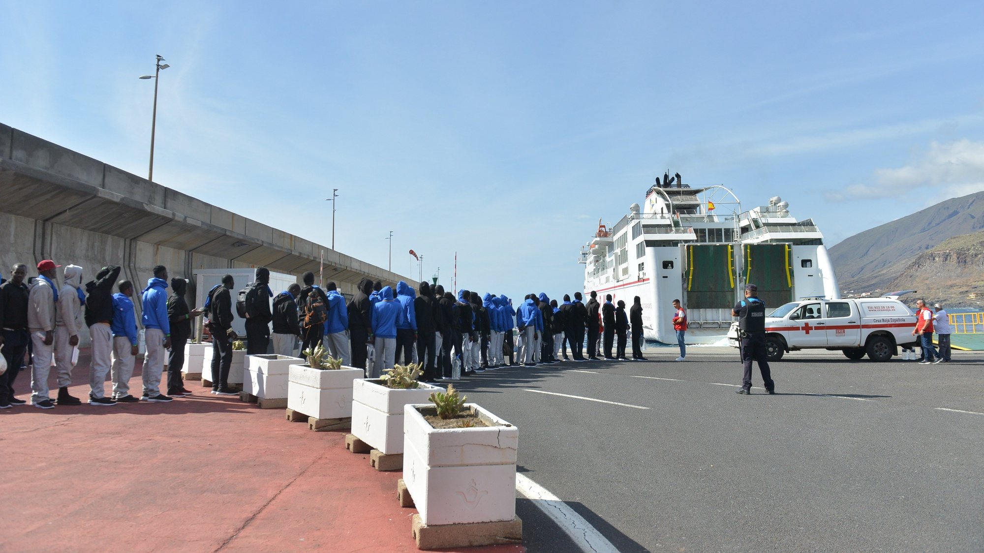 epa10854678 Migrants await before being transfered to Tenerife on board a ferry of Spanish ferry services company &#039;Naviera Armas&#039; from Valverde&#039;s port in El Hierro island, Canary Islands, Spain, 11 September 2023. A total of 313 migrants will be transfered to Tenerife after reaching the Spanish coasts on board of small boats.  EPA/GELMERT FINOL