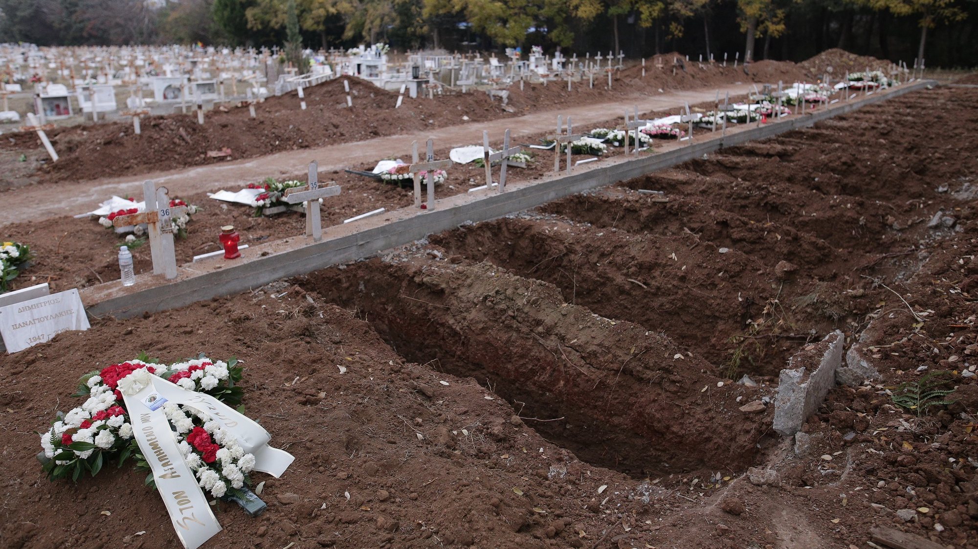 epa08859942 Special burial sites for the dead from coronavirus (COVID-19) are dug out on the Municipal Cemetery of the Resurrection of the Lord, in Thessaloniki, Greece, 03 December 2020. New graves are being opened by municipal crews while Thessaloniki is still at the center of the second wave of the pandemic, with the National Public Health Organization in Greece (EODY) recording 453 cases out of a total of 2,186 on 02 December.  EPA/ACHILLEAS CHIRAS