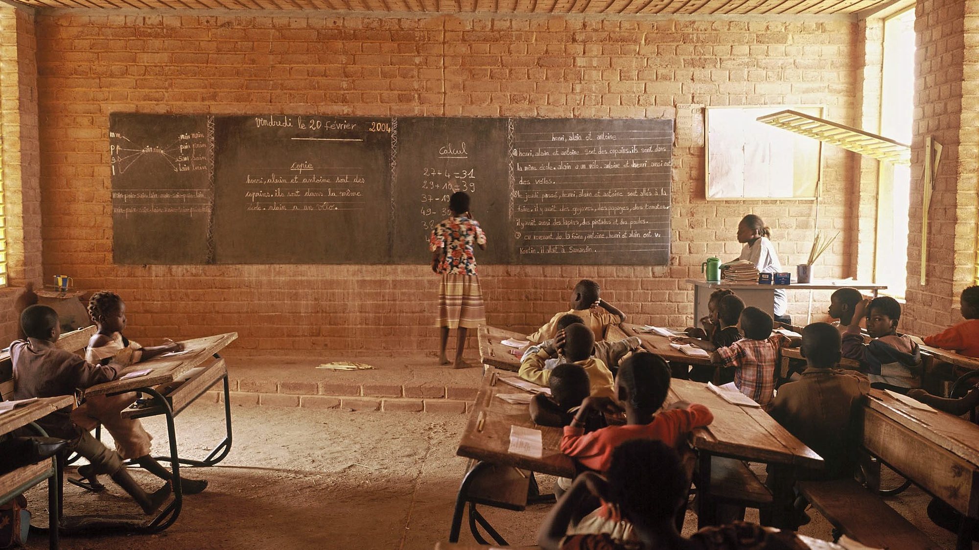 Children sit inside a classroom in an innovative school design in Gando, Burkina Faso. The Primary School won the 2004 Aga Khan Award for Architecture on 28 November 2004 for projects that have attained the highest international standards of architectural excellence while reflecting the values of the primarily Muslim societies the projects are intended to serve. The primary school &quot;goes far beyond its educational programme and exemplifies highest-calibre architectural design employing locally available materials and techniques, training and community participation and empowerment&quot;. EPA/SIMEON DUCHOUD-THE AGA KHAN AWAR