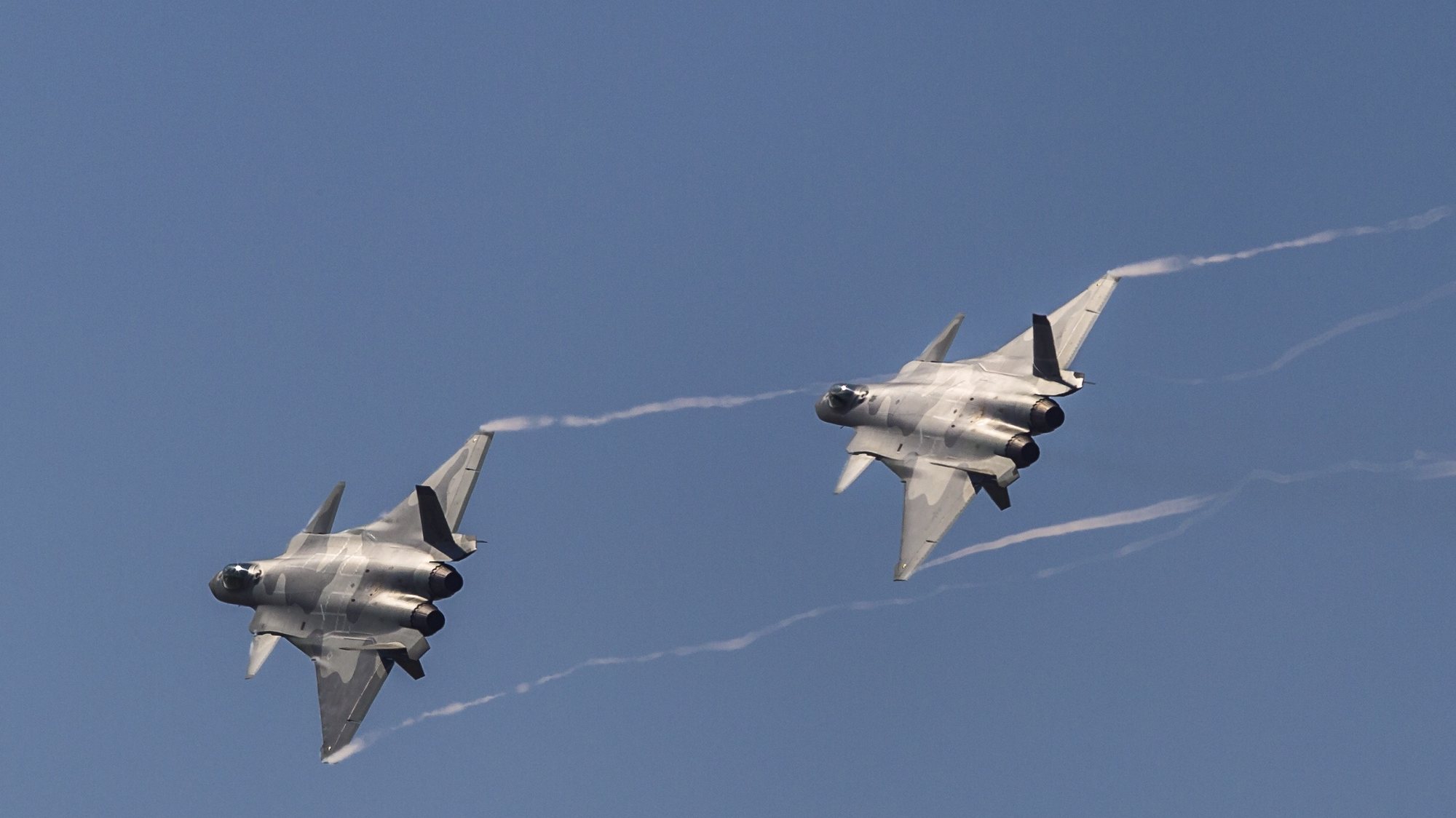 epa07144126 Two Chinese J-20 &#039;Chengdu&#039; stealth fighter jets perform during a flying display on the first day of a military airshow in Zhuhai, Guangzhou province, China, 06 November 2018. The China International Aviation and Aerospace Exhibition, China&#039;s largest international aerospace trade show, runs until 11 November 2018.  EPA/ALEKSANDAR PLAVEVSKI