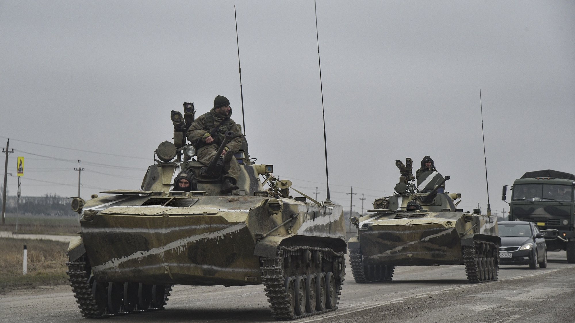 epa09784384 Russian soldiers on the amphibious infantry fighting vehicle BMP-2 move towards mainland Ukraine on the road near Armiansk, Crimea, 25 February 2022. Russian troops entered Ukraine on 24 February prompting the country&#039;s president to declare martial law and triggering a series of announcements by Western countries to impose severe economic sanctions on Russia.  EPA/STRINGER