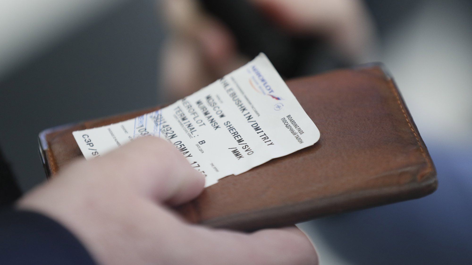 epa07549917 A passenger holds his passport and a boarding pass at Aeroflot&#039;s Sheremetyevo airport terminal, after the fire which emerged while the Sukhoi Superjet 100 of Russian airline Aeroflot plane crashlanded was put out at Moscow&#039;s Sheremetyevo airport, Russia, 05 May 2019. According to authorities, at least 13 people died after the plane had to make an emergency landing just after take off for the flight to Murmansk.  EPA/SERGEI ILNITSKY