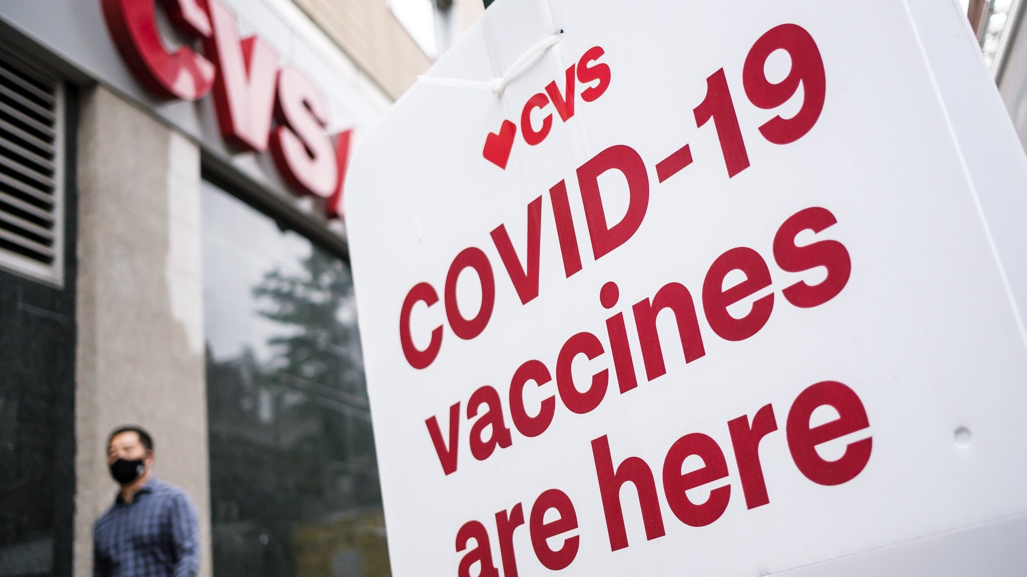 epa09175952 A person walks past a sign for COVID-19 vaccines outside of a CVS pharmacy, one of two national pharmacy chains providing vaccination shots around the country, in the Brooklyn borough of New York, New York, USA, 03 May 2021. According to data from the United States’ Centers for Disease Control and Prevention there were reportedly 182,874 wasted vaccine doses, much of made by Pfizer which requires being stored at extreme low temperatures, as of late March. Over half of the reported waste has been attributed to CVS.  EPA/JUSTIN LANE