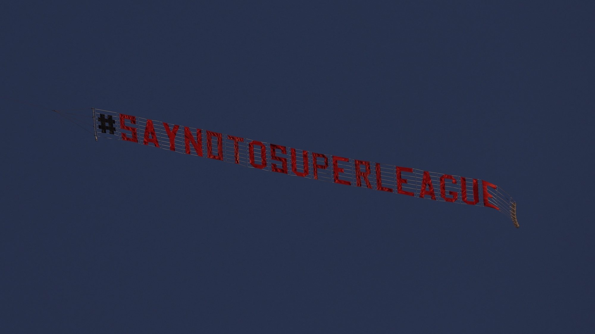 epa09146084 A flying banner written &#039;SAY NO TO SUPER LEAGUE&#039; is seen over the Elland Road stadium ahead of the English Premier League soccer match between Leeds United and Liverpool FC in Leeds, Britain, 19 April 2021.  EPA/Clive Brunskill / POOL EDITORIAL USE ONLY. No use with unauthorized audio, video, data, fixture lists, club/league logos or &#039;live&#039; services. Online in-match use limited to 120 images, no video emulation. No use in betting, games or single club/league/player publications.