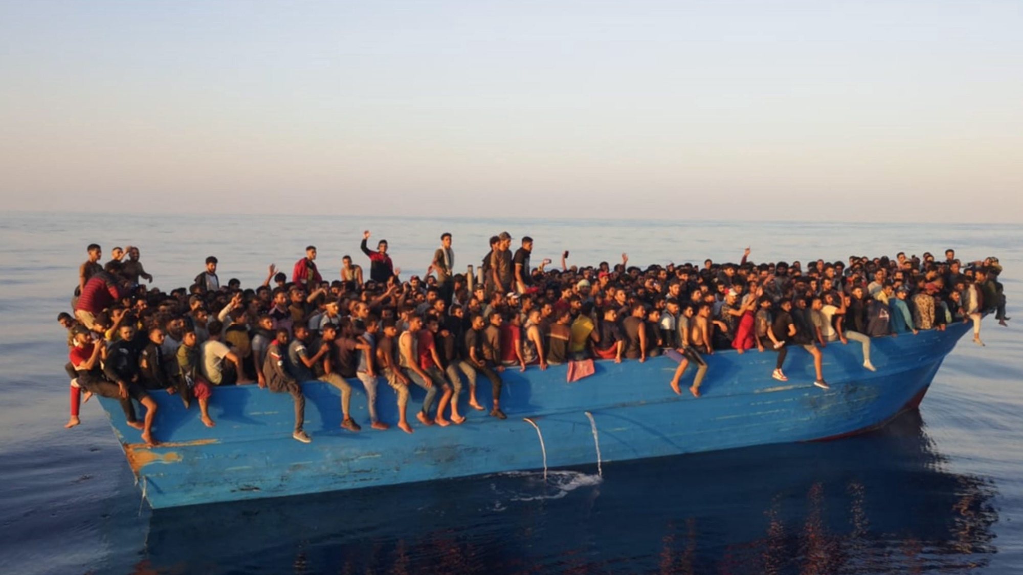 epa09433267 The approximately 400 migrants on a boat off the island of Lampedusa, Italy, 28 August 2021. The migrants were transferred to patrol boats and boats of the Capitaneria di Porto (Harbor Master&#039;s Office) and brought to the port of Lampedusa.  EPA/CONCETTA RIZZO