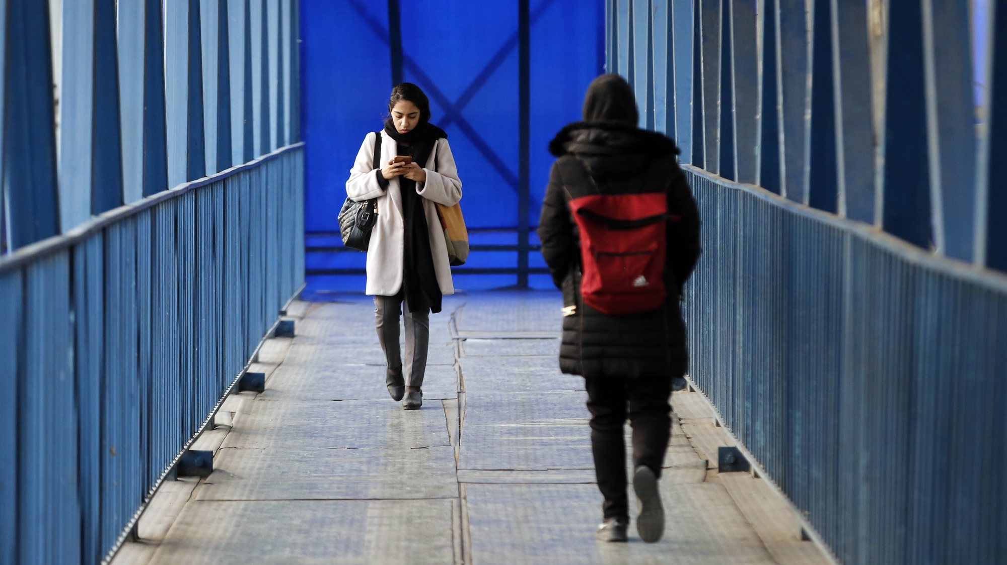 epa10398202 Iranian women walk on a pedestrian bridge in Tehran, Iran, 10 January 2023. According to Isna news agency Attorney General of the country has ordered Iranian police to &quot;firmly punish&quot; women who violate Iran&#039;s Hijab (dress code) in the streets. The decision comes amid the worldwide protests against Iranian government following the death of Masha Amini, a 22 year old girl, who was detained on 13 September 2022 by the police unit responsible for enforcing Iran&#039;s strict dress code for women.  EPA/ABEDIN TAHERKENARE