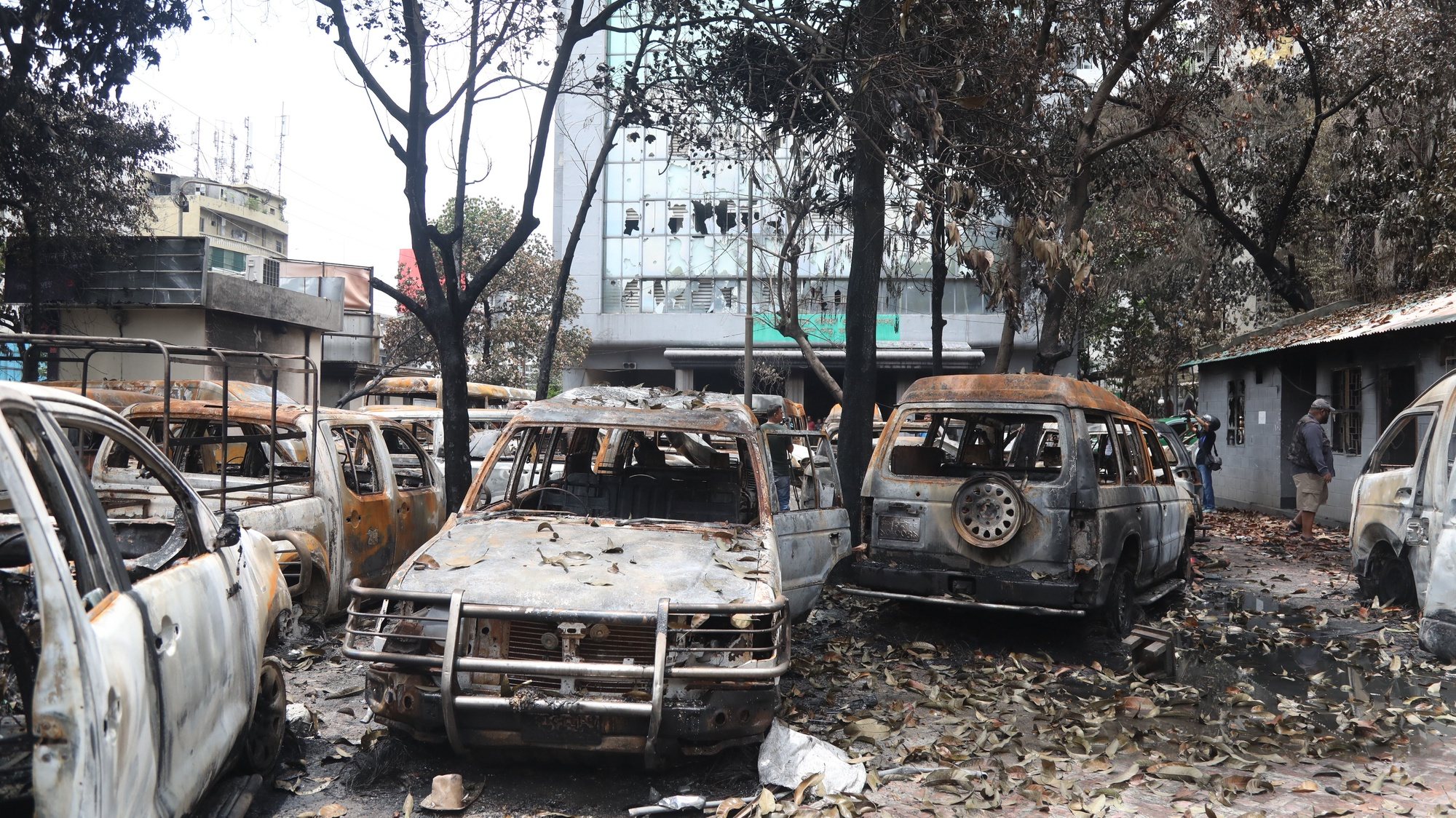 epa11491083 Burnt vehicles are seen outside a government building after protests in Dhaka, Bangladesh, 22 July 2024. On 22 July Bangladesh was under curfew; widespread disruption of telecoms prevailed a day after the Bangladesh Supreme Court scrapped some quotas for government jobs that sparked protests, and police were authorized to enforce &#039;shoot on sight&#039; orders across the country during curfew as casualties mounted and law enforcement struggled to contain the unrest. The Bangladeshi government imposed a nationwide curfew and deployed military forces after violence broke out in Dhaka and other regions following student-led protests demanding reforms to the government&#039;s job quota system.  EPA/MONIRUL ALAM