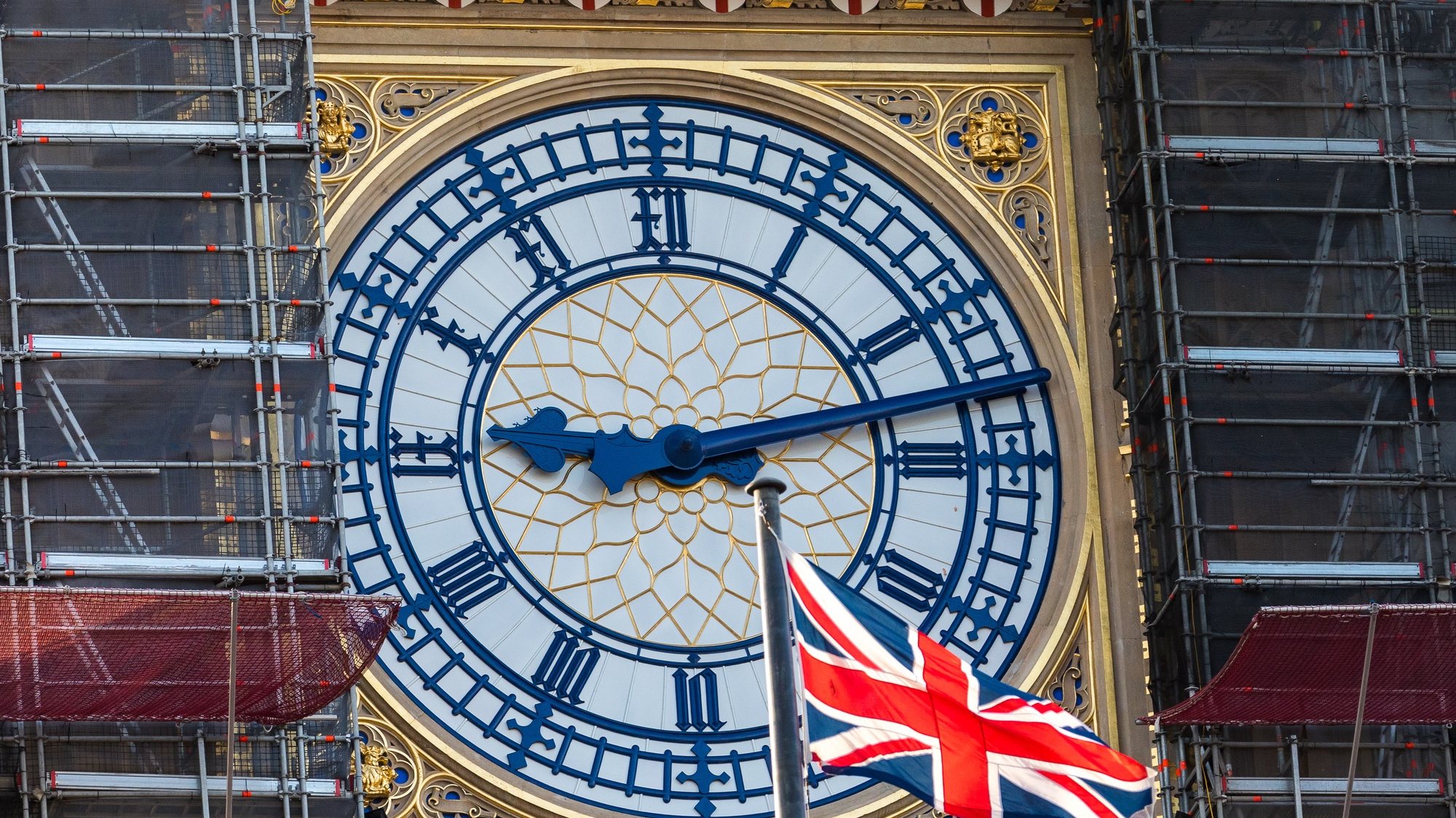 epa08863203 A Union Jack flag waves next to the clock face of Big Ben in Westminster, London, Britain, 05 December 2020. British and EU negotiators have paused Brexit talks because they say significant divergences remain and the conditions for a deal between the two sides have not been met.  EPA/VICKIE FLORES