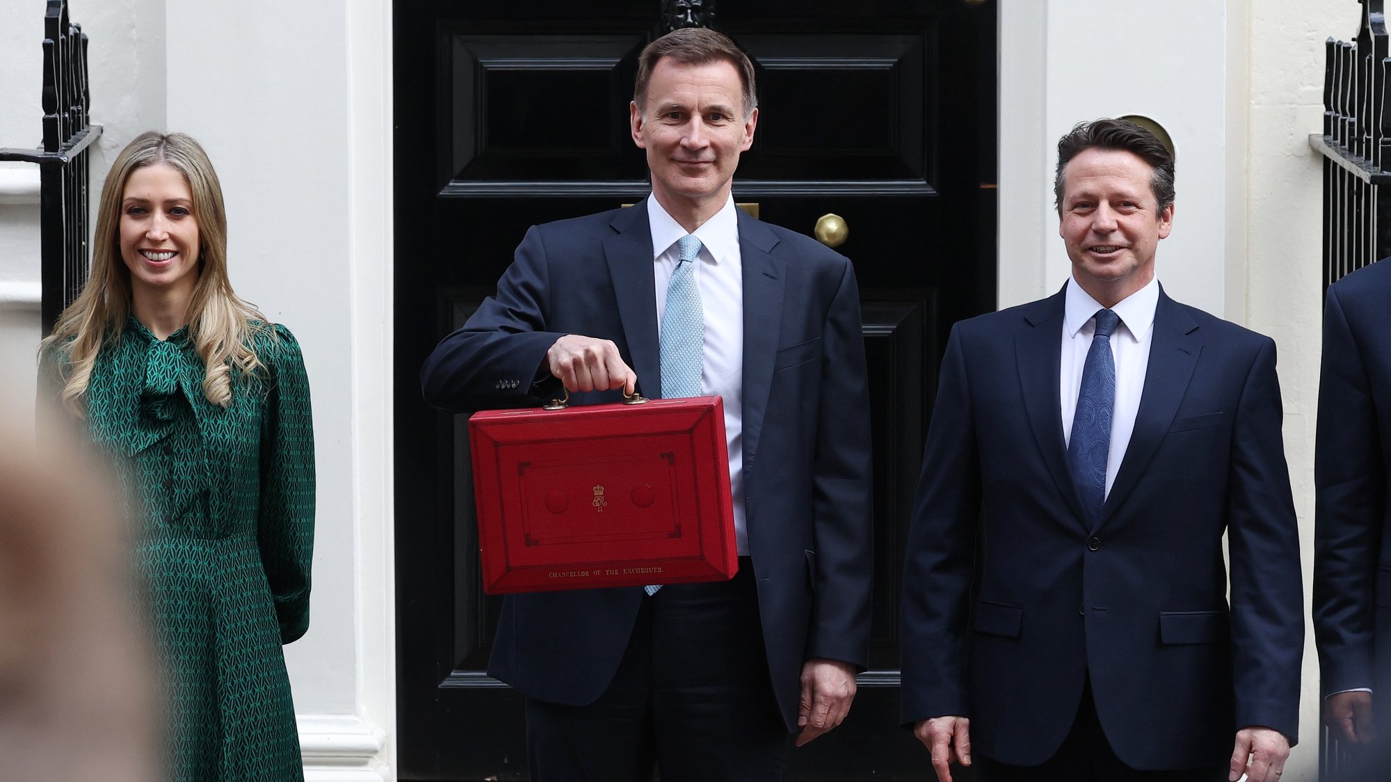 epa11201753 British Chancellor of the Exchequer Jeremy Hunt (C) poses with his budget box outside 11 Downing Street In London, Britain, 06 March 2024. Hunt will announce his budget to parliament with a cut to National Insurance expected.  EPA/ANDY RAIN