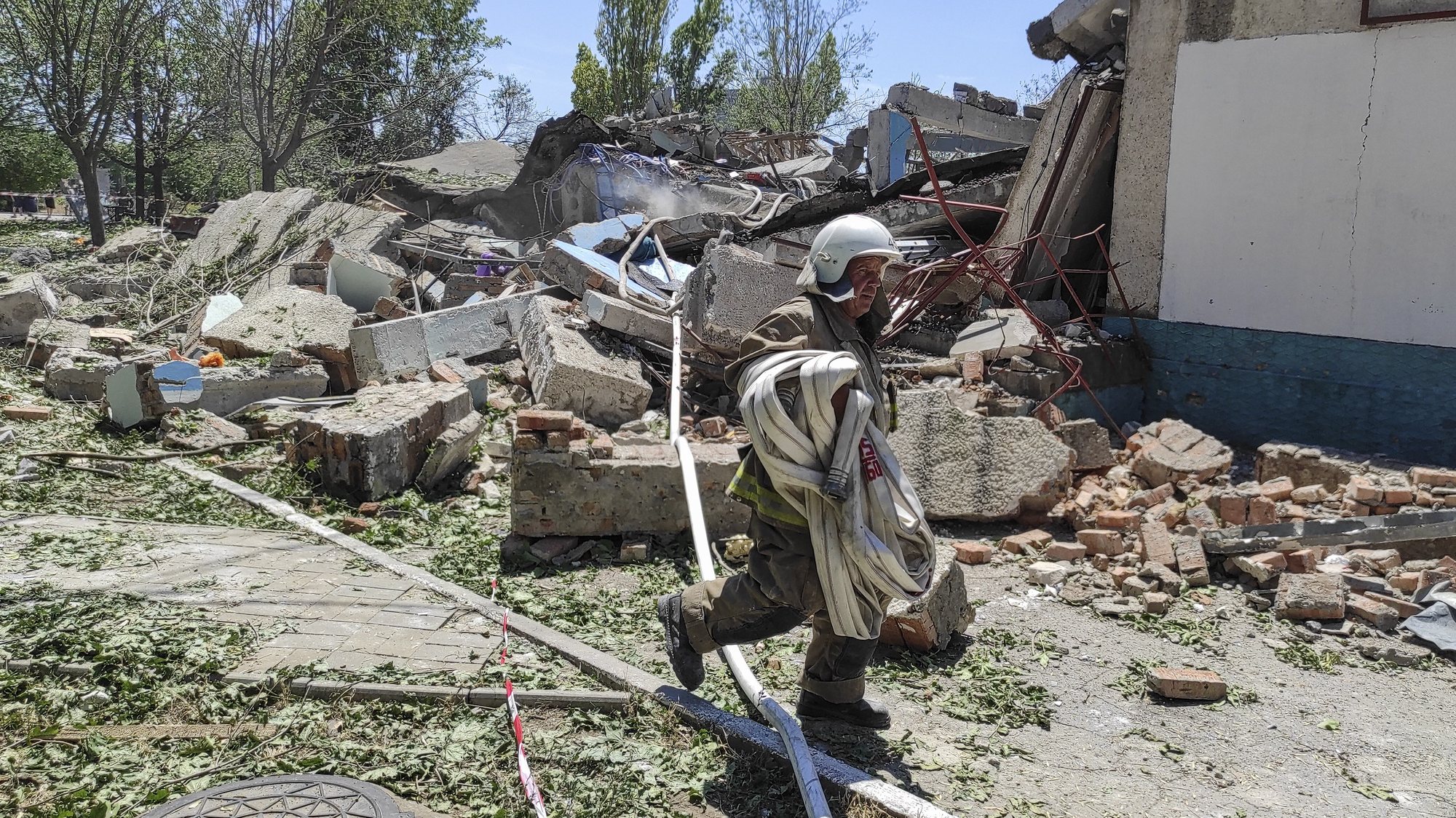 epa10045459 A rescuer works at the scene of a damaged residential building after shelling hit the small town of Serhiivka near Odesa, southern Ukraine, 01 July 2022. At least 19 people were killed and 38 others injured, including six children, after overnight shelling hit a nine-story building and two holiday hotels in Serhiivka, Bilhorod-Dnistrovskyi district, Odesa region, the state emergency service said in a statement on 01 July.  EPA/STRINGER