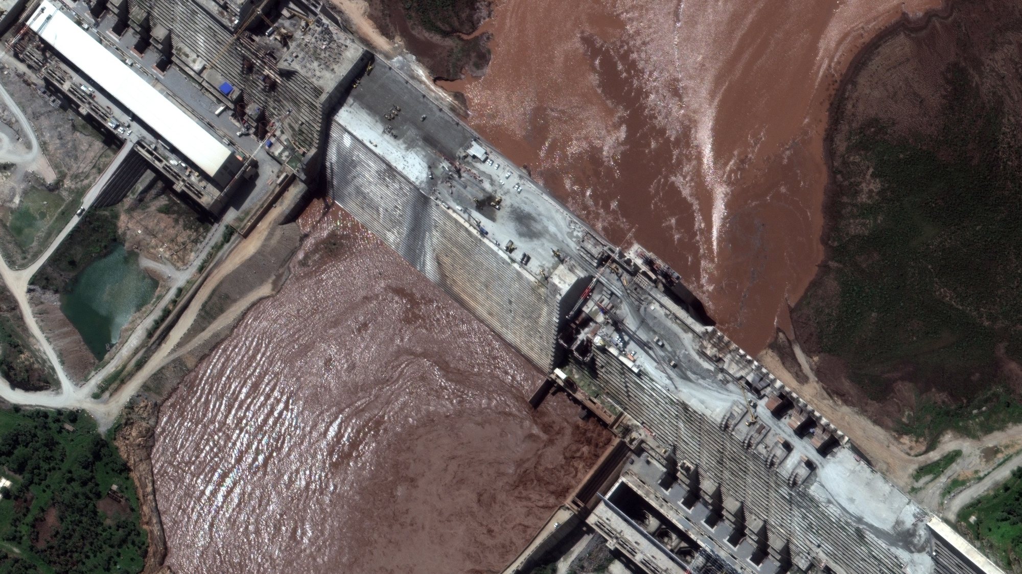 epa08548879 A satellite image made available by MAXAR Technologies shows a close-up view of the Grand Ethiopian Renaissance Dam (GERD) and the Blue Nile River, in the Benishangul-Gumuz region of Ethiopia, 26 June 2020 (issued 16 July 2020). The GERD dam on the Blue Nile River in Ethiopia has been under construction since 2011. The project affects Sudan and Egypt as the Blue Nile river flows north from the dam and is of vital importance to the Nile River. Recent satellite imagery revealed a large reservoir that started to fill behind the dam.  EPA/MAXAR TECHNOLOGIES HANDOUT -- MANDATORY CREDIT: SATELLITE IMAGE 2020 MAXAR TECHNOLOGIES -- the watermark may not be removed/cropped -- HANDOUT EDITORIAL USE ONLY/NO SALES